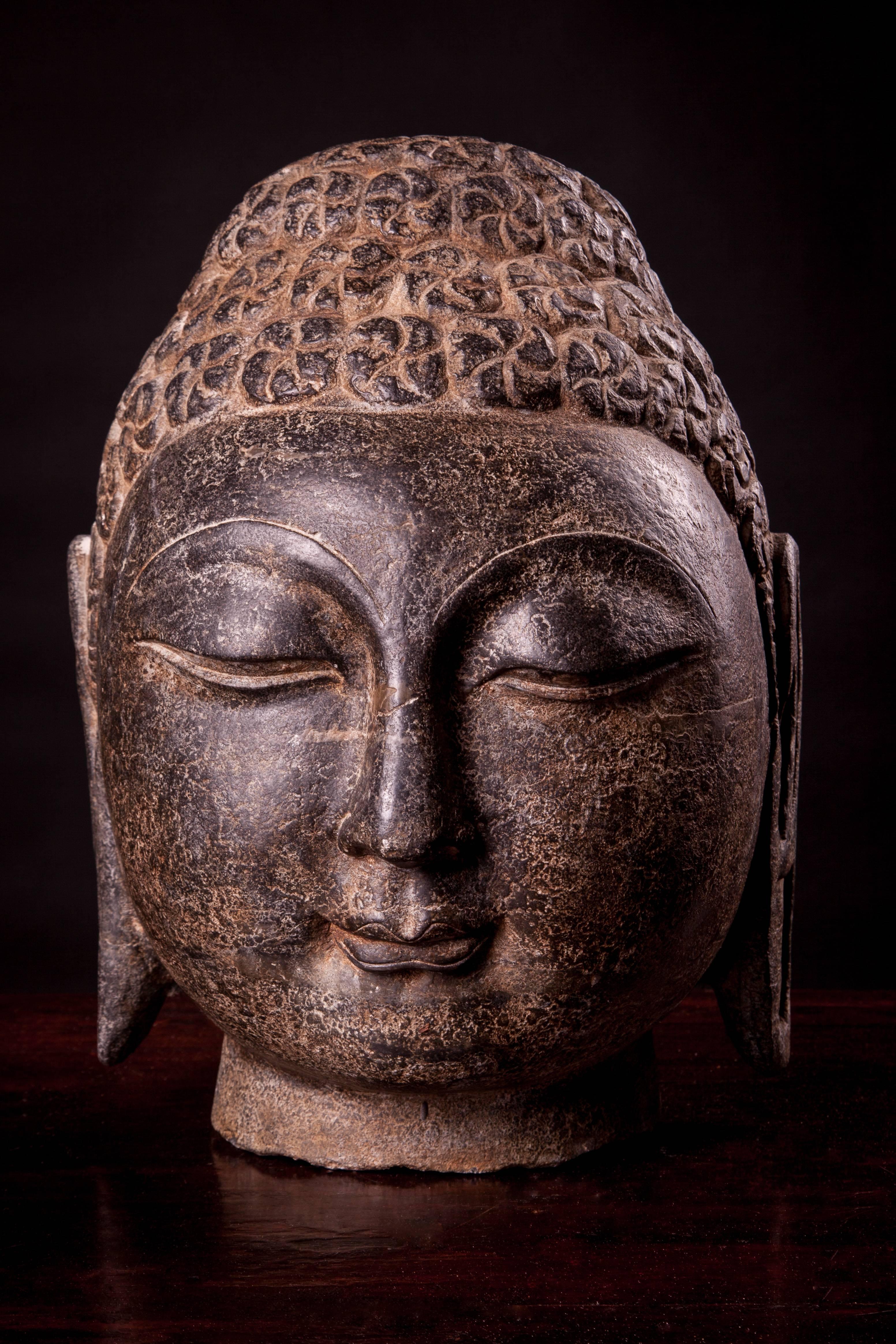 Mid-late Qing dynasty, circa 1900, stones carved Shakyamuni Buddha heads.

Known as the Gautama Shakyamuni Buddha, the face is supposed to express the moment of awakening/enlightenment, so Gautama Buddha represents the first enlightened one, whose