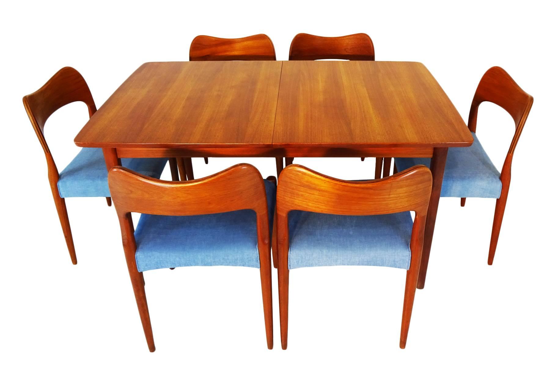 Set of six dining chairs and extending dining table with two leaves. The chairs were designed by Arne Hovmand Olsen and manufactured by Mogens Kold, Denmark, circa 1960 and the table by Nils Jonsson manufactured in Sweden also circa 1960 and