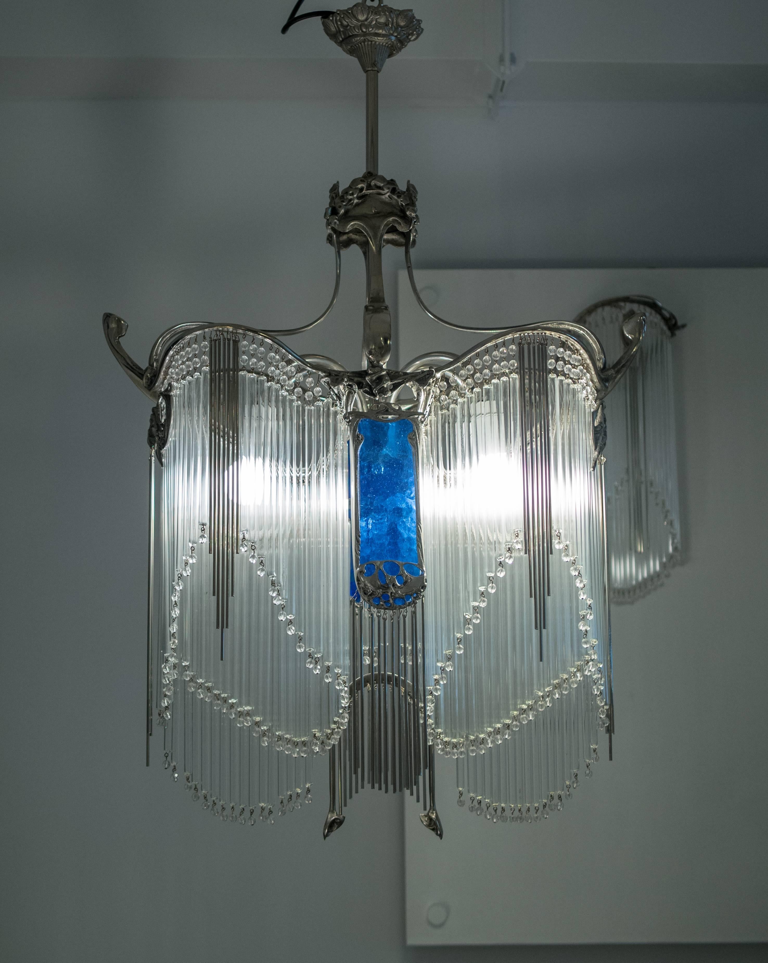 Art Nouveau Bronze chandelier with nickel patinated finish and glass tubes.