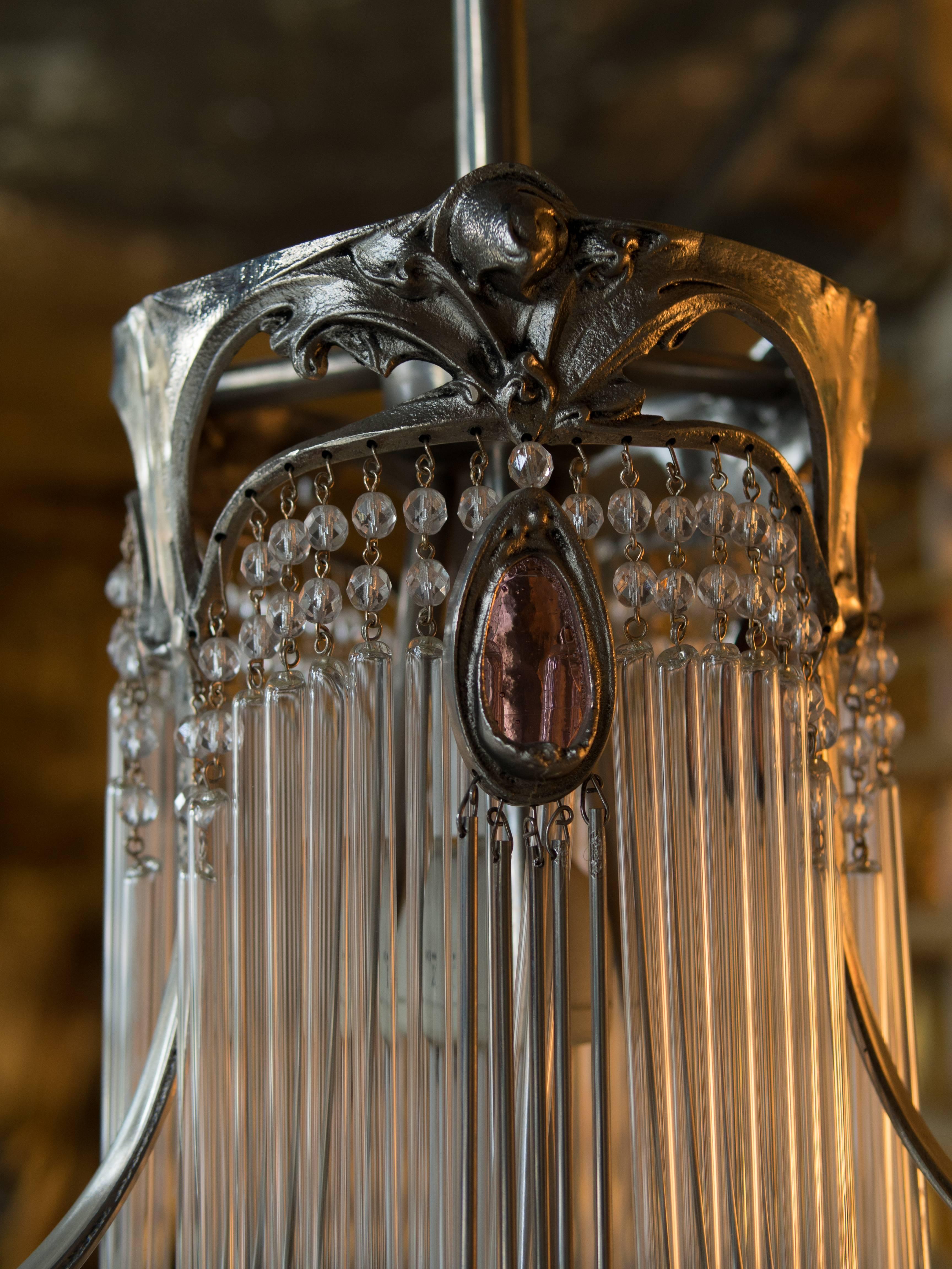 Art Nouveau chandelier from Hector Guimard. Bronze with patinated nickel finish and purple glasses (lie de vin).