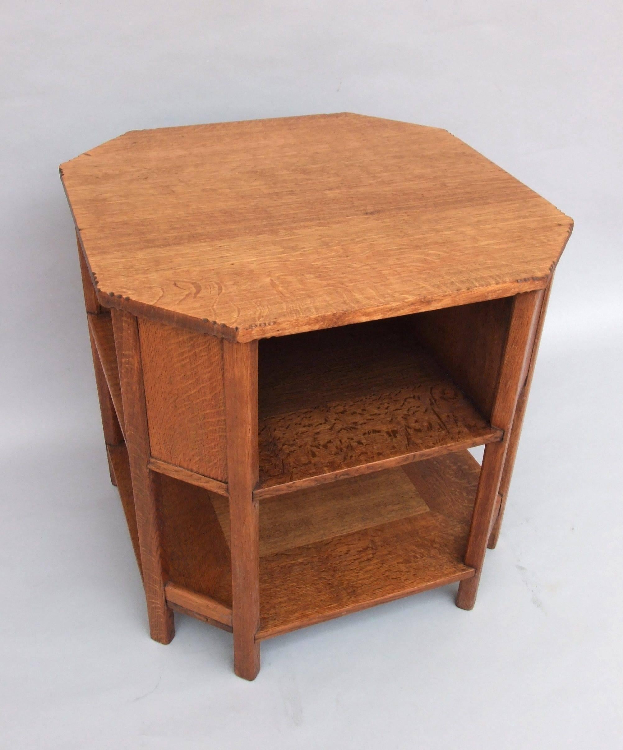 A quarter sawn oak Arts & Crafts octagonal book or coffee table with eight legs and chip carving to the top by Heal & Son, circa 1920. Measures: 62cm (24in) high, 62cm (24in) wide, 62cm (24in) deep. Illustrated p.83 'A History of Heal's' by