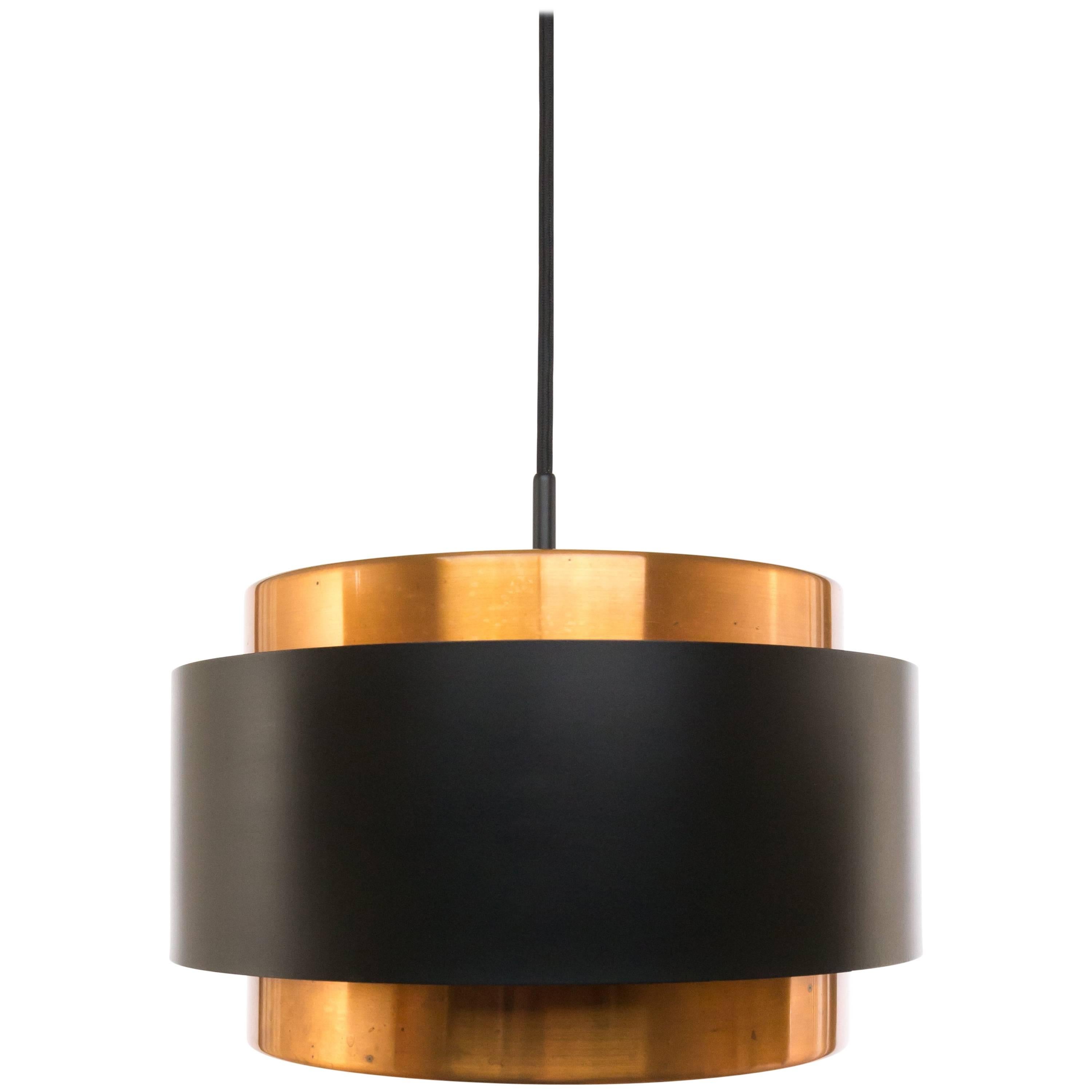 Pair of pendants named Saturn, designed by Danish designer Jo Hammerborg and manufactured by Fog & Mørup.

The lamp is a structure of two concentric cylindrical copper bands that are held together by a black lacquered band. At the top and the