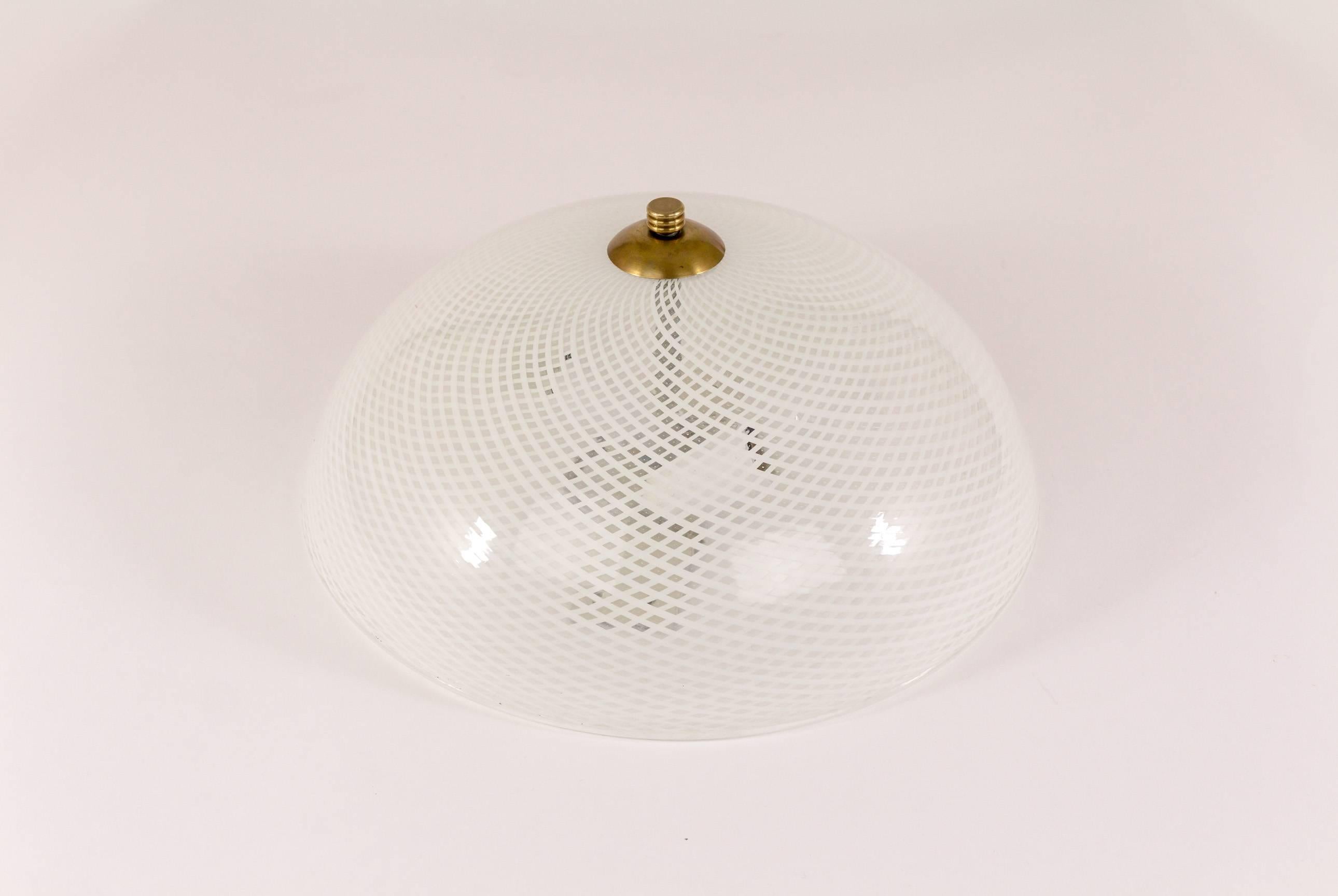 A pair of elegant round ceiling lights with reticello glass by Venini, with brass mounts. Reticello which translates into 