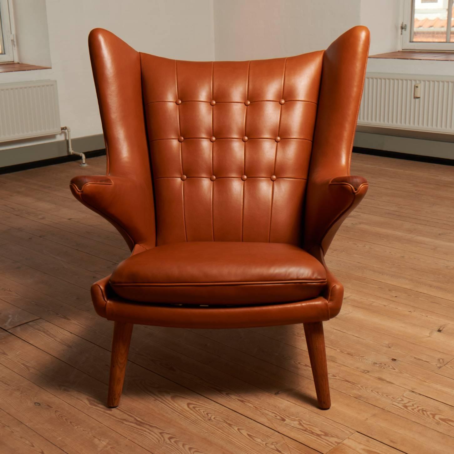 Hans J. Wegner AP19 Papa Bear chair newly upholstered in walnut elegance leather.
Legs and nails are in teak.