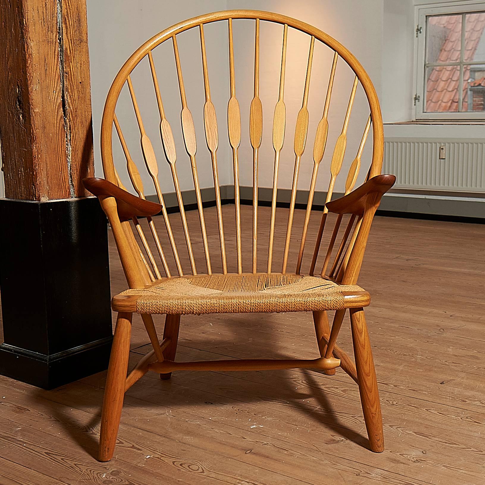 An original Peacock chair from the 1970s in oak and with arms of teak. The seat is of papercord. The chair is in a very good condition.