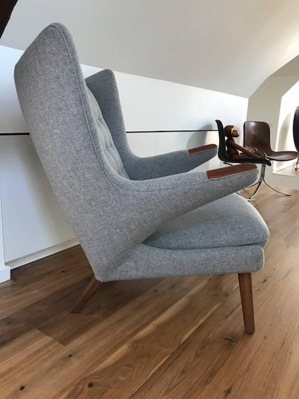 Hans J. Wegner AP19 Papa Bear chair newly upholstered in light grey Tonica wool, code 171. 
Legs in oak and nails in mahogany.