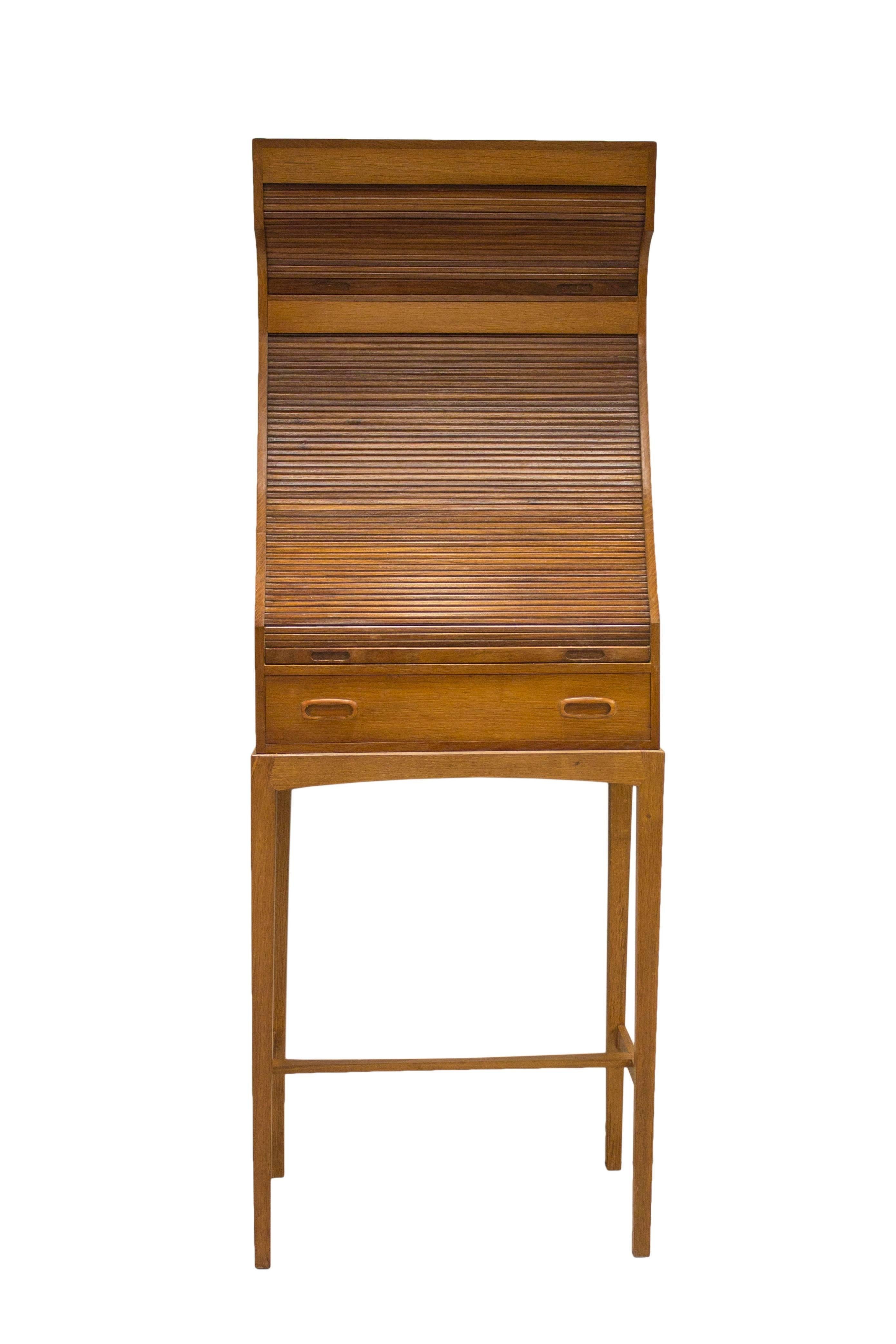 The Mid-Century movement saw a resurgence of pieces using Tambour door techniques to create stunning and practical furniture.

This wonderful piece in excellent refinished condition features two storage sections both concealed behind upward