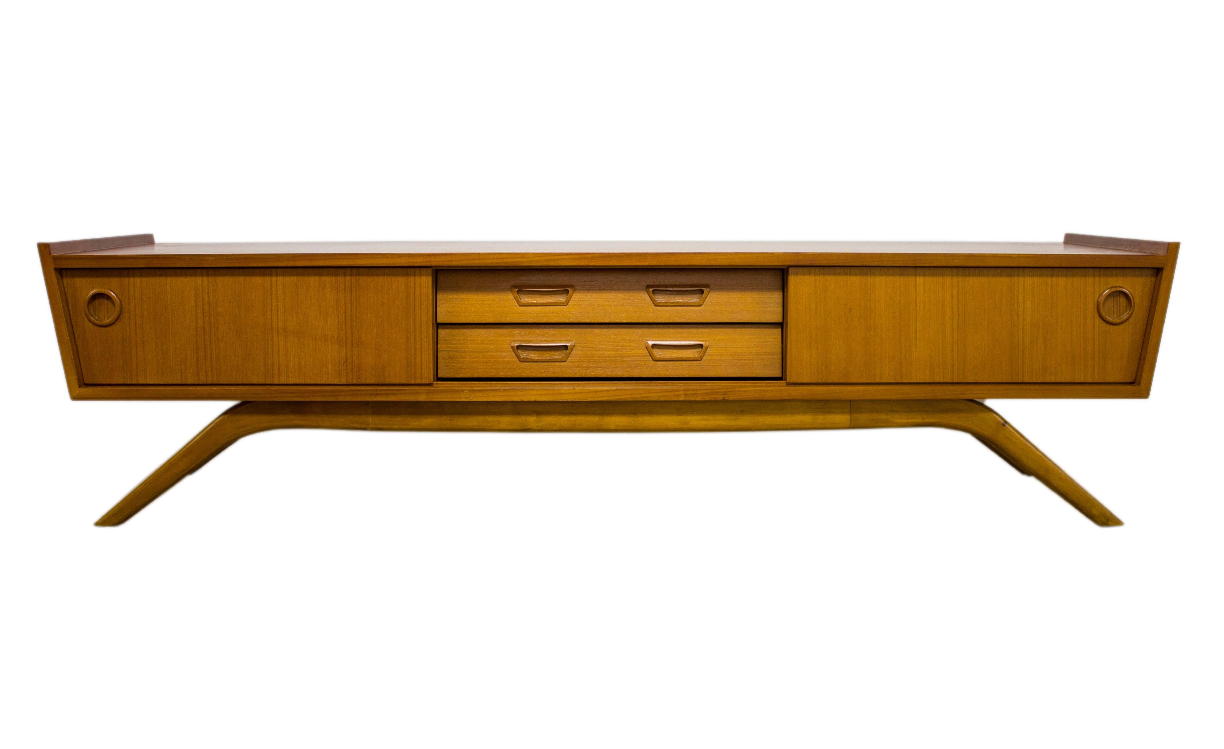 The Danish designers of the midcentury movement brought clean, simple lines to the masses and introduced the world to the wonders of Teak in it’s many guises, stunning grain and rich colors.

This stunning low level sideboard with its organic