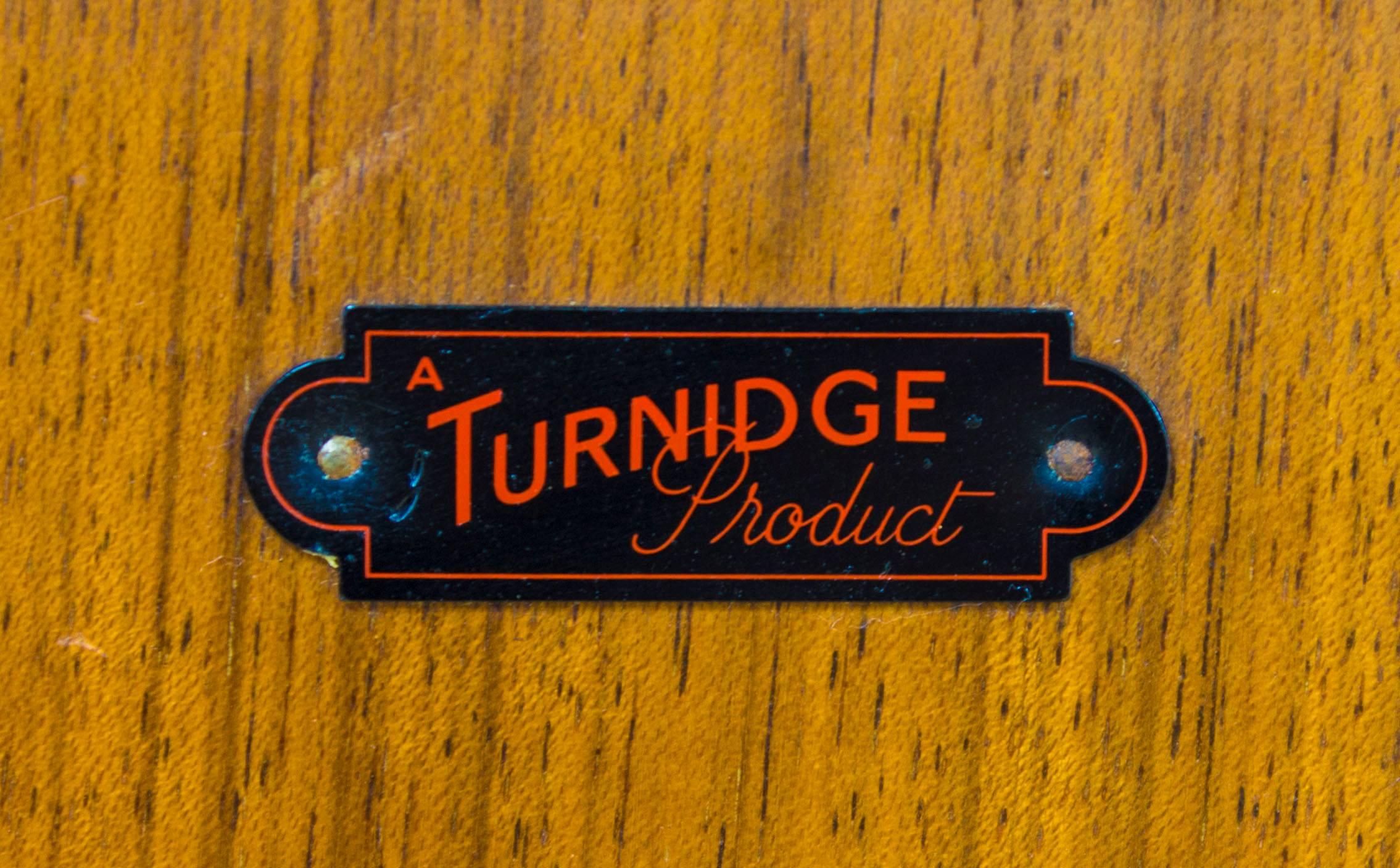 Turnidge of London created stunning furniture ranges from the UK based design studios, taking everyday and popular items and adding a unique and very British twist establishing them as a leader in the early British midcentury market.

This