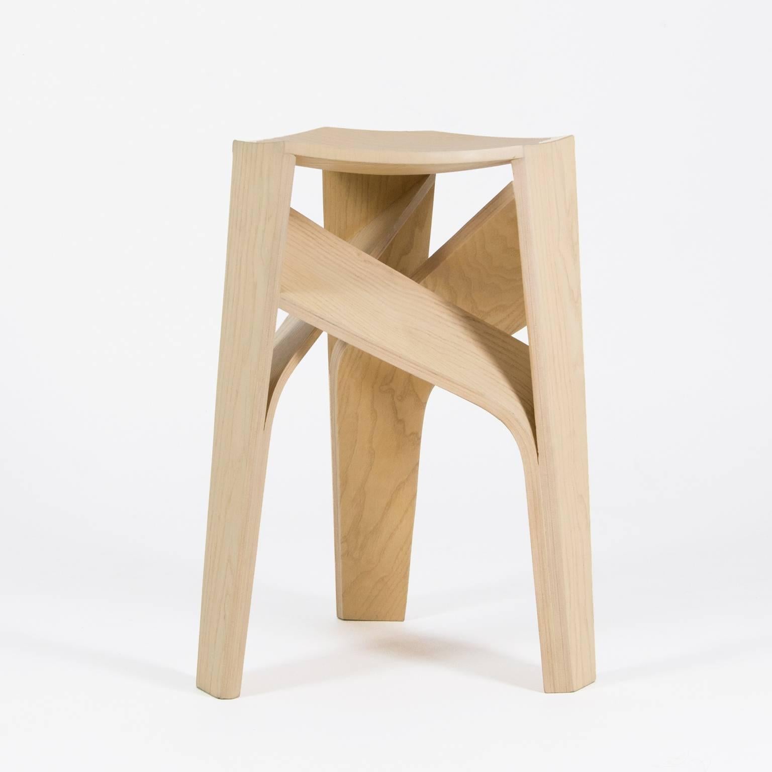 Aero stool is the result of mastering the process of bending wood, it features a geometrical intersection of its three legs, a technical feat achieved through meticulous digital and artisanal methods. The shape of Aero is an ingenious solution that