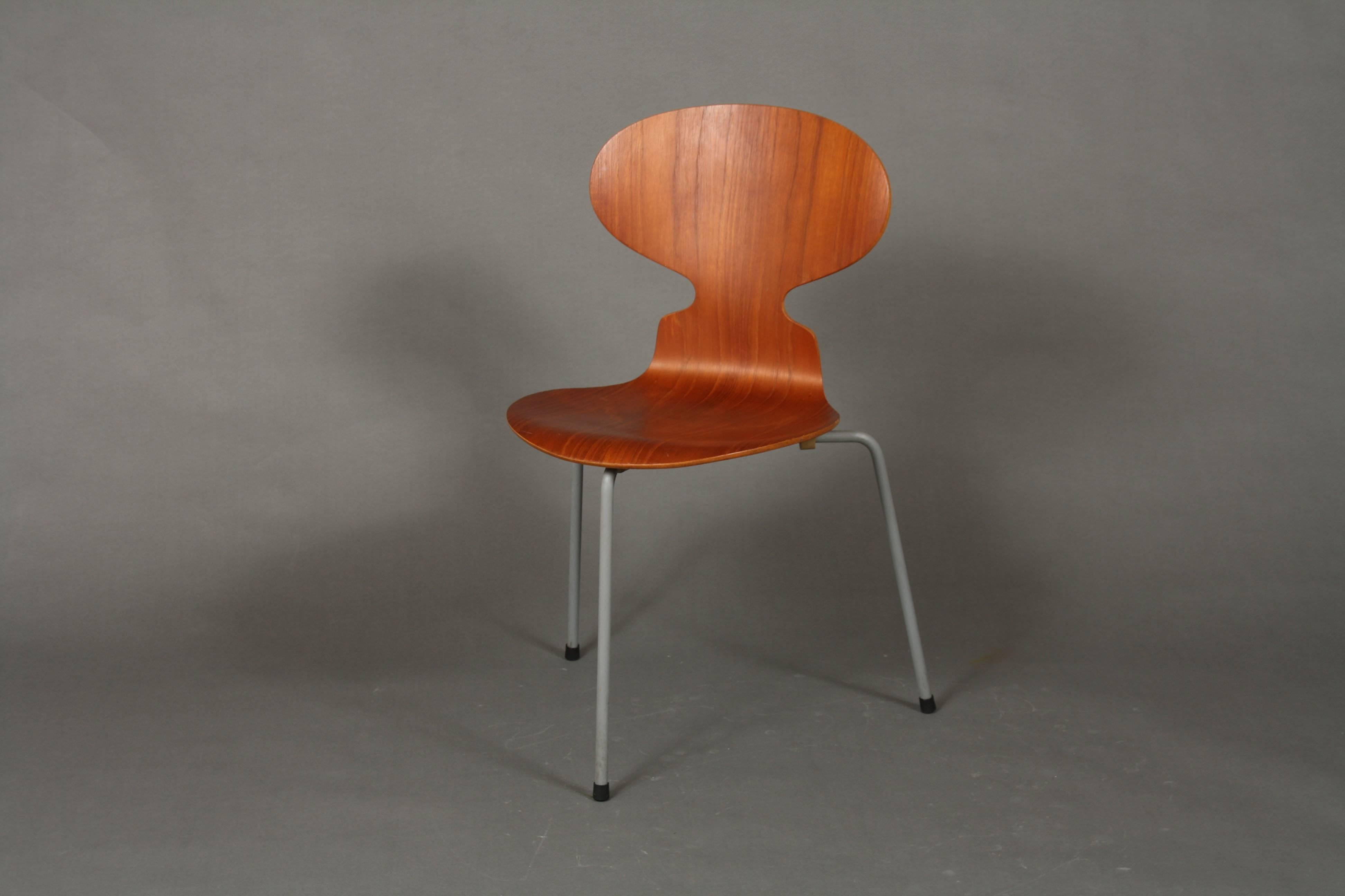 Set of two teak early three legged Arne Jacobsen ant chairs manufactured by Fritz Hansen. The legs are original and covered with grey rubber.