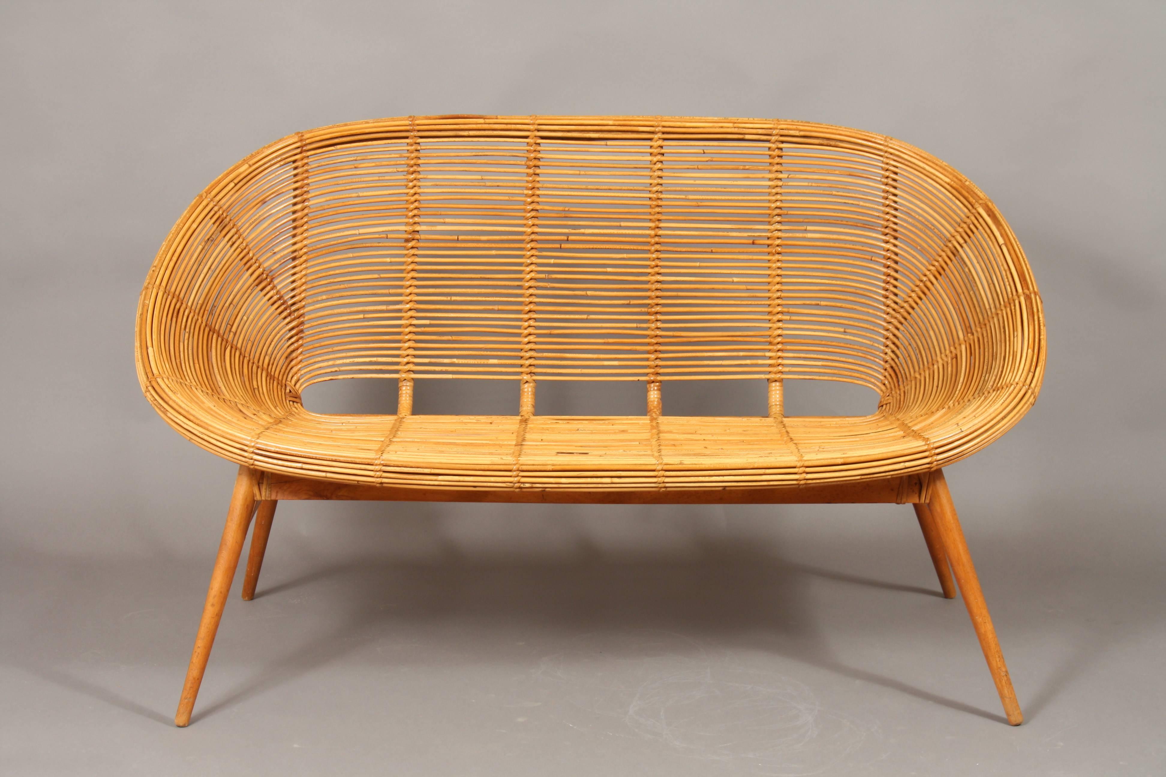 Very beautiful vintage wicker sofa with teak frame. The design is nicely organic. The condition is excellent and it will fit in the modern home. 
I have a chair for sale in similar design. (See pictures).
Its made in the old East Germany (DDR)