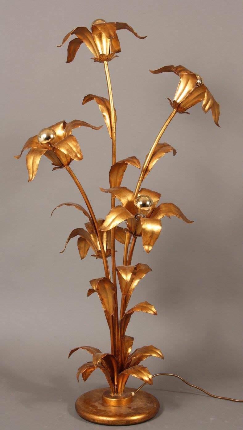 A beautiful floor lamp by Hans Kogl with five big flowers with shielded light bulbs. The lamp is made of gold painted metal and will bring beauty to your home.