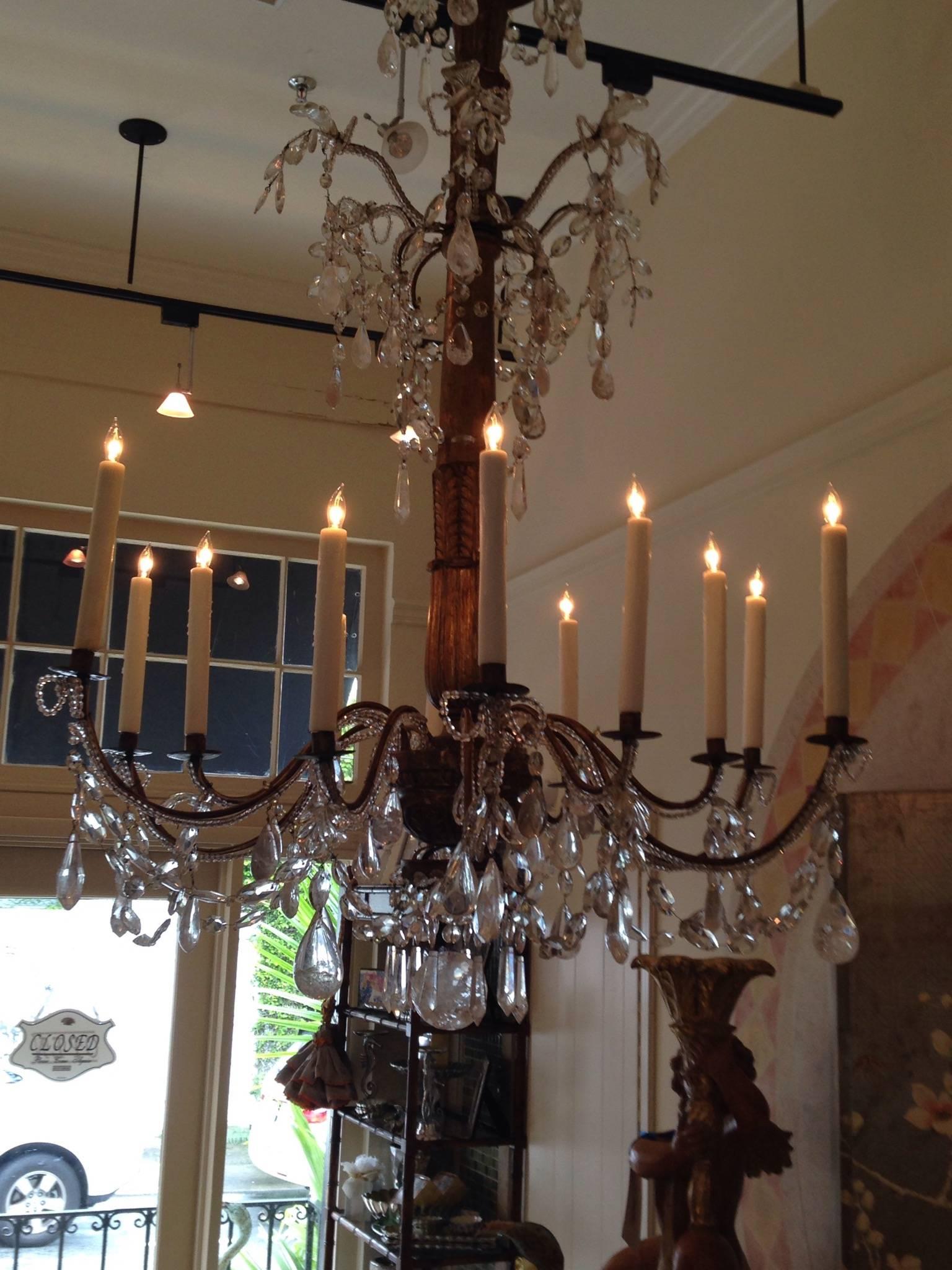 Late 18th-early 19th century colossal Genovese chandelier. Giltwood stem with 12 arms.
Rock crystal drops.