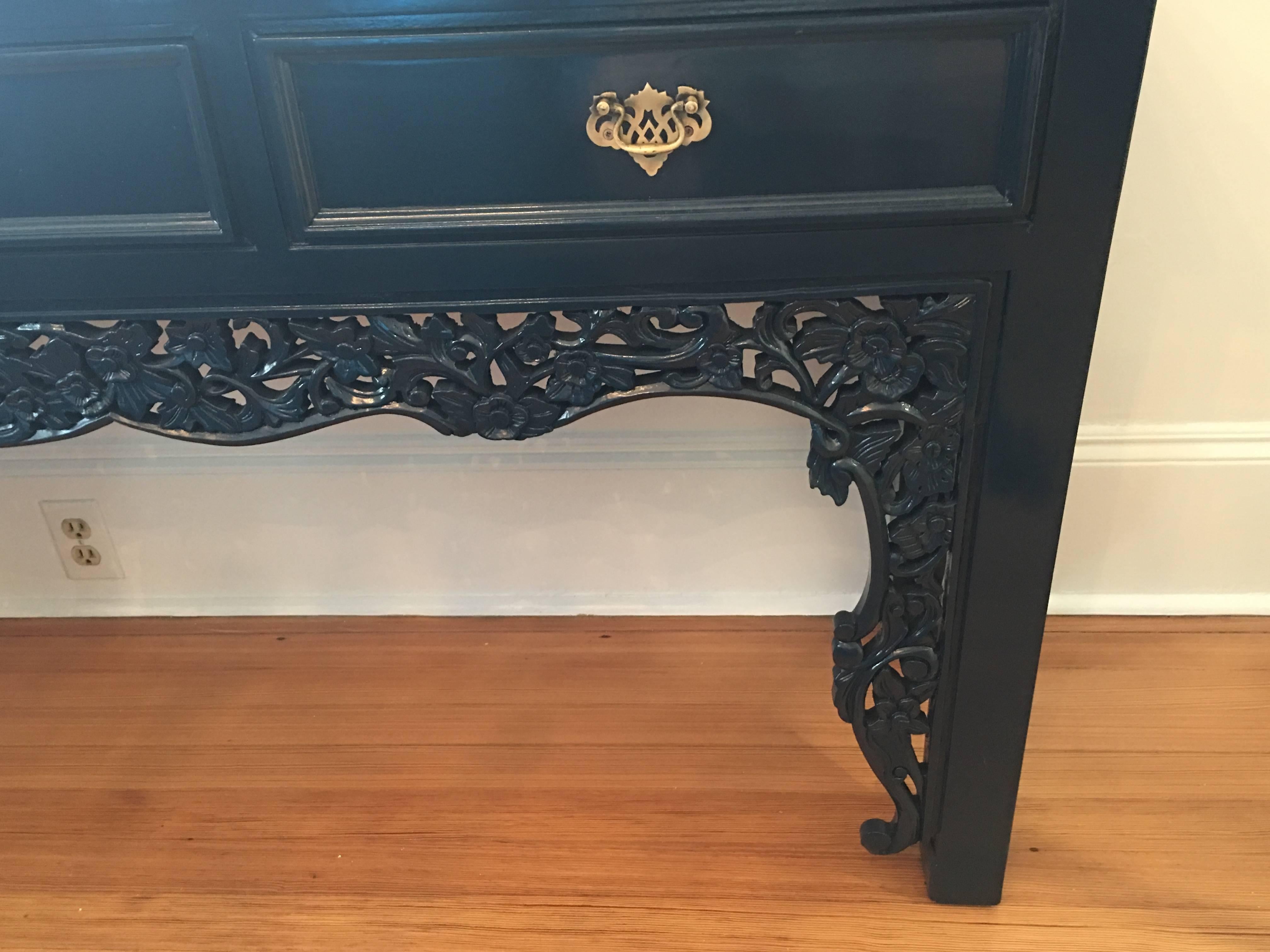 Midcentury carved three drawers (with brass pulls) lacquered navy blue console table.
