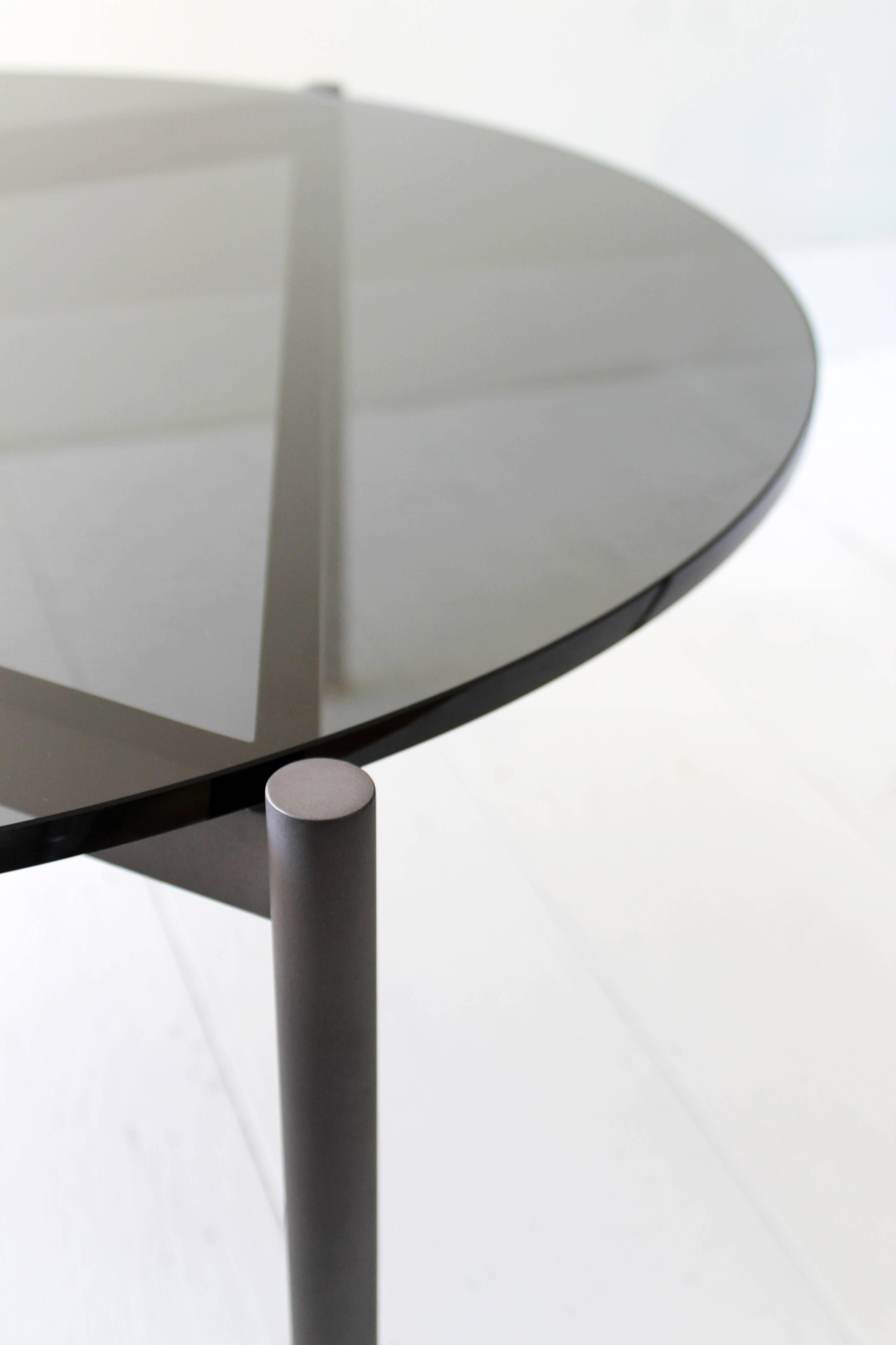 Available in two heights, the triangulated blackened steel base design allows you to nest multiple tables. Mix and match from our standard surface options, or contact us to customize your own.