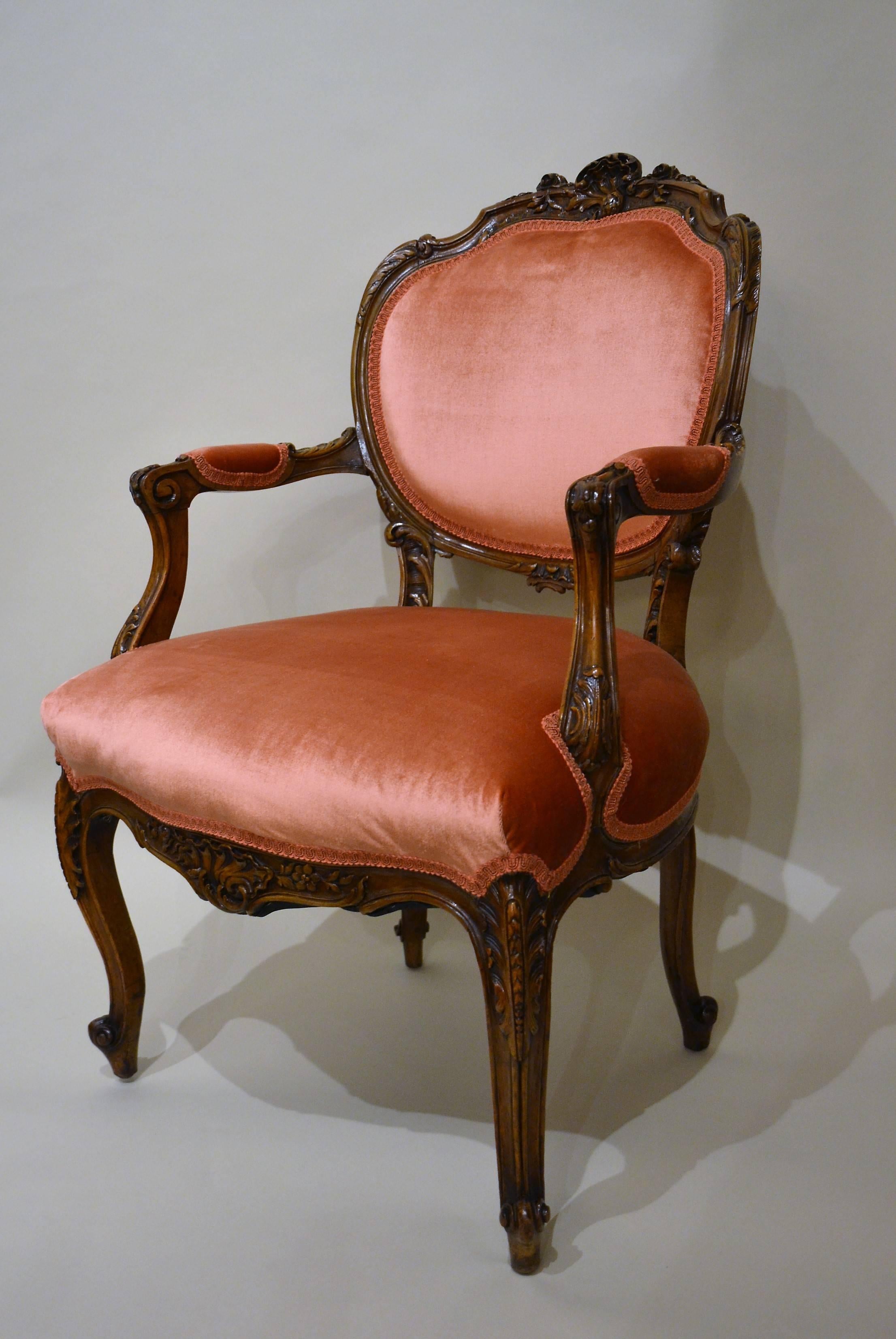 Pair of antique French sculpted walnut armchairs, circa 1875-1885.