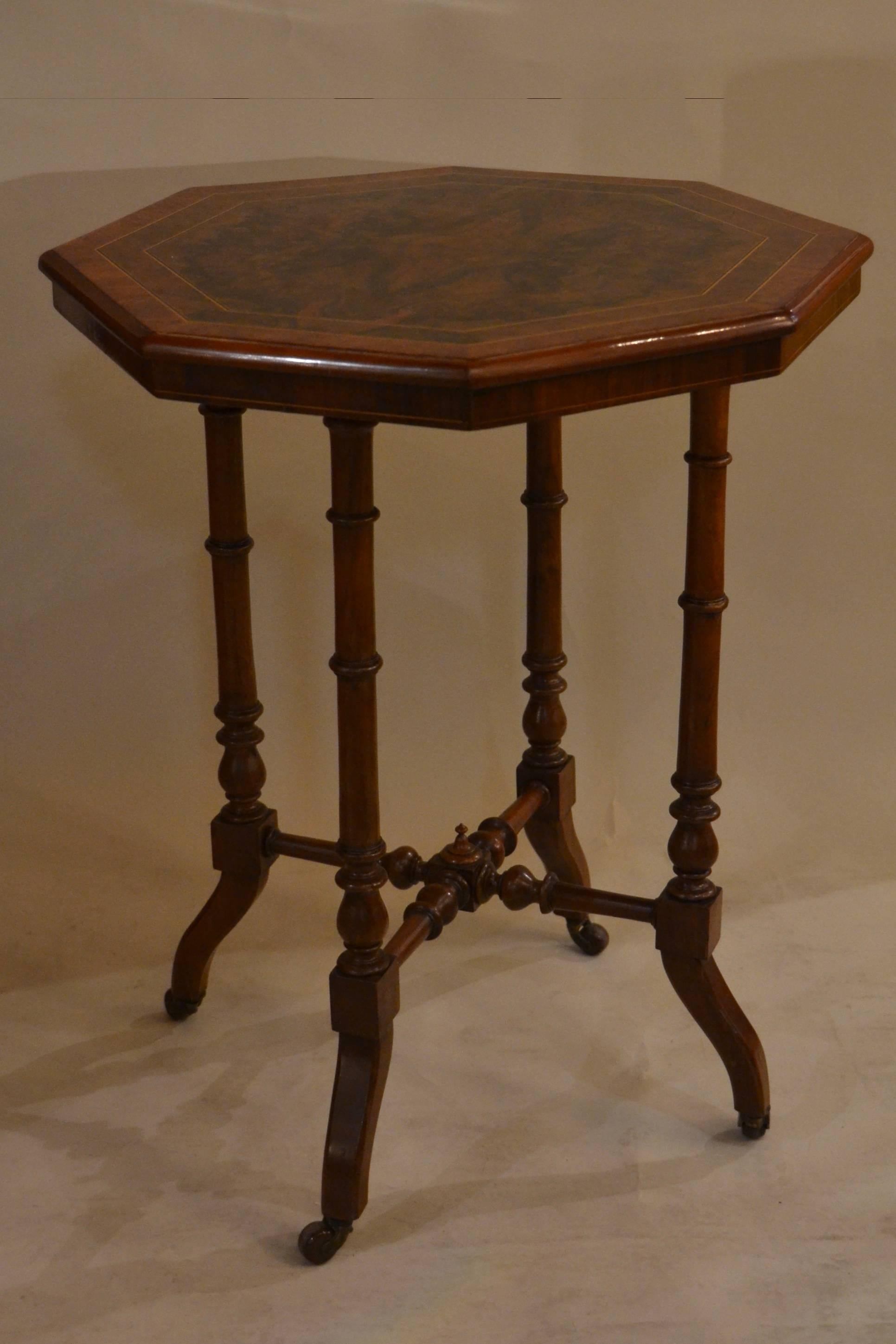 A nicely made occasional table with two bands of inlay following the octagonal form of the piece. The bulr is of fine color and grain.