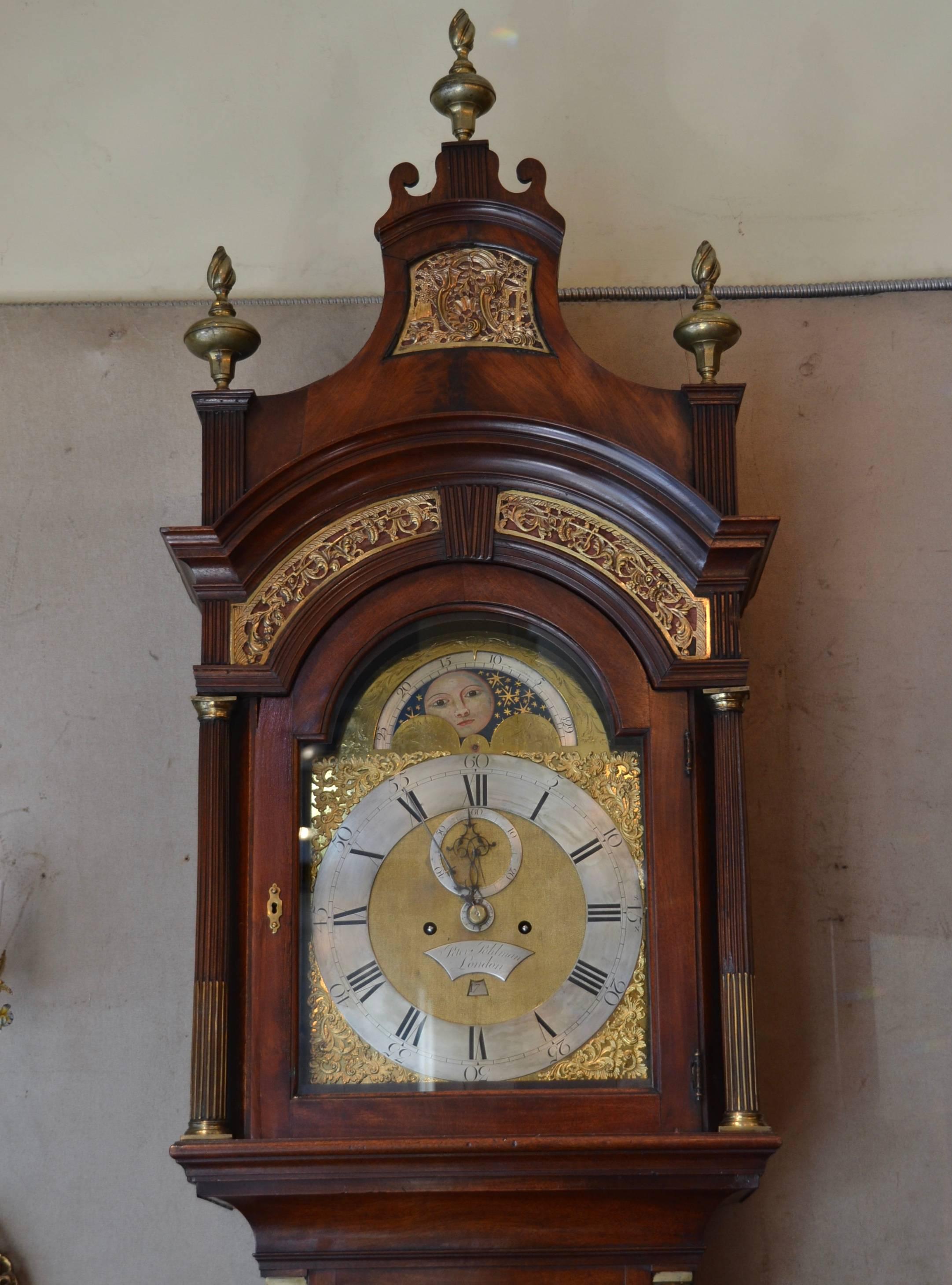 Antique English George III flame mahogany tall case clock by Peter Pohlman, circa 1760. This clock has 8 day movement striking on the hour with moon phase and second hand and calendar function.
