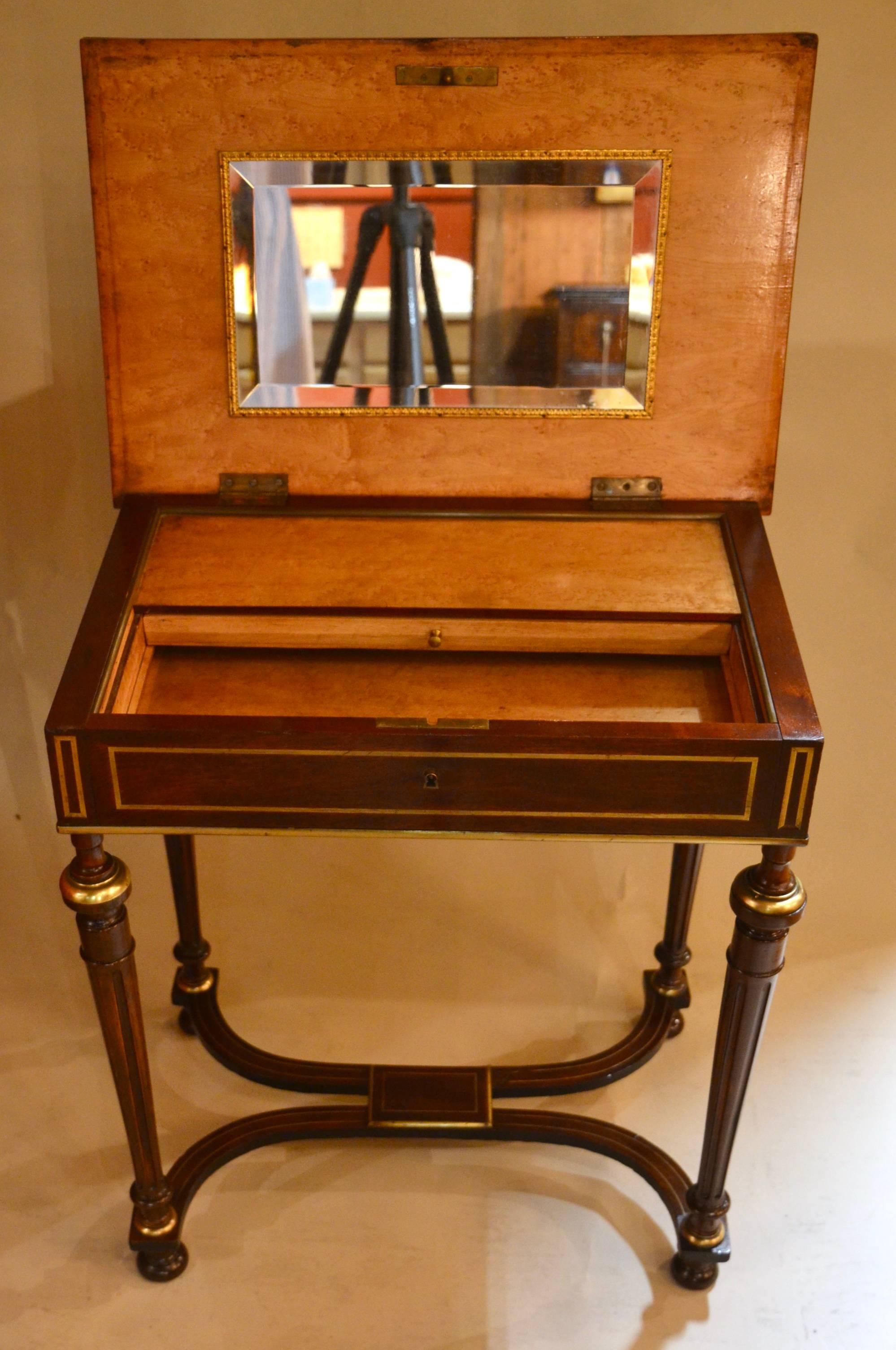 This dressing table has a mirror inside and is nicely decorated.