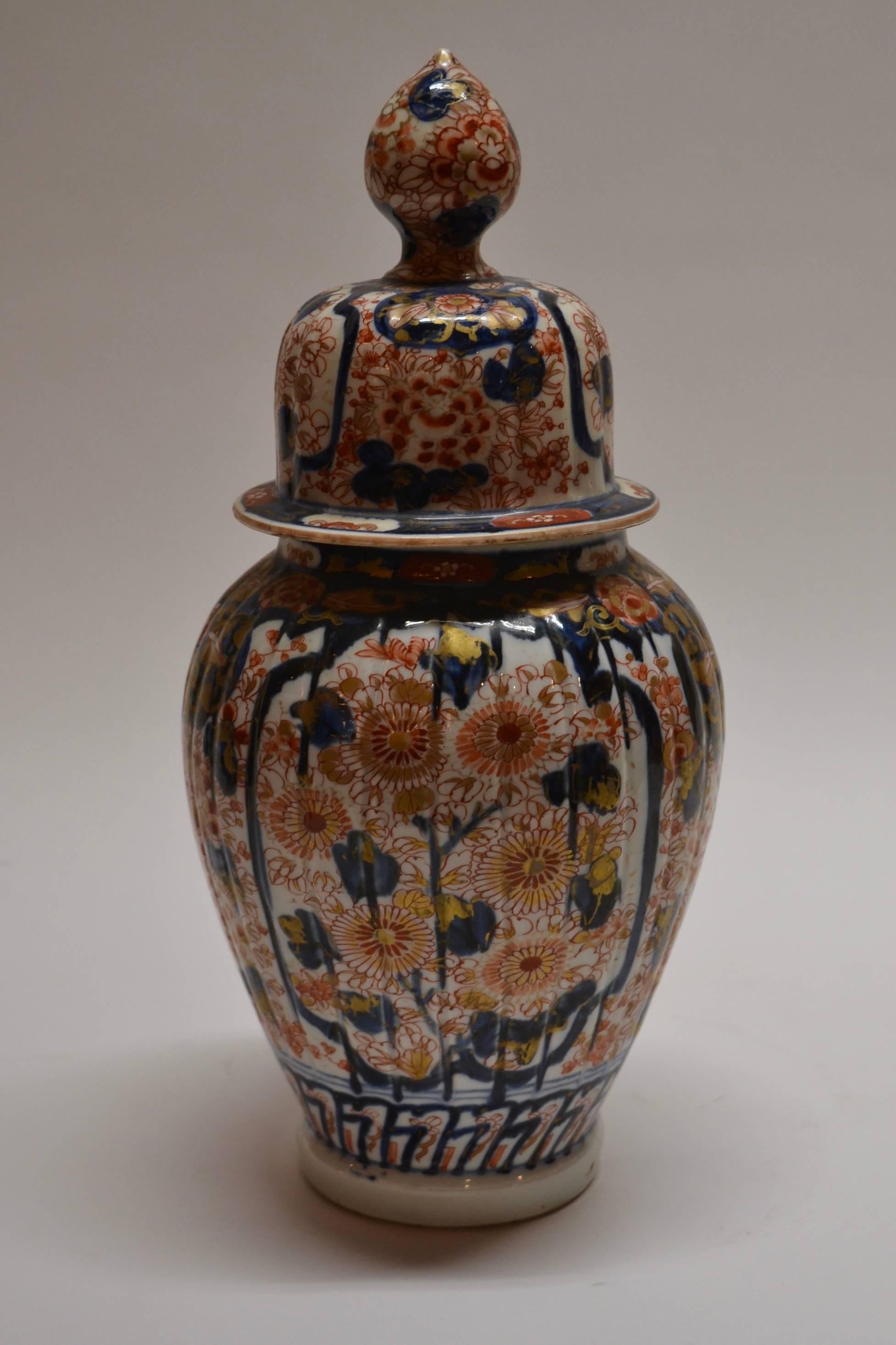 Pair of antique Imari vases and covers, circa 1860.
