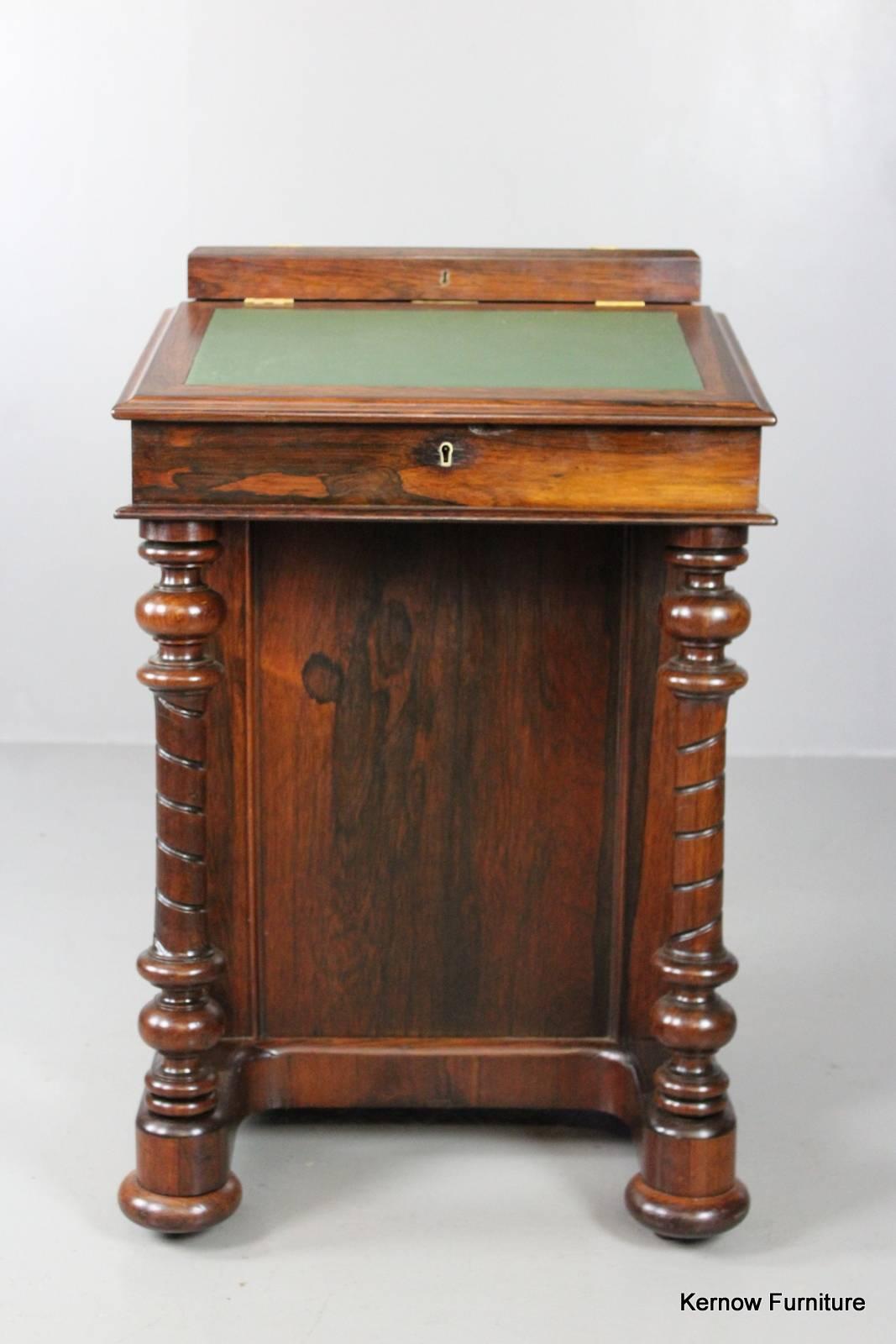 Antique Victorian rosewood Davenport. Internal paper label for Parkinsons cabinet makers, market place, Richmond. Four drawers and four dummy drawers, sloping hinged writing surface with internal skiver and fitted drawers, small hinged box to the