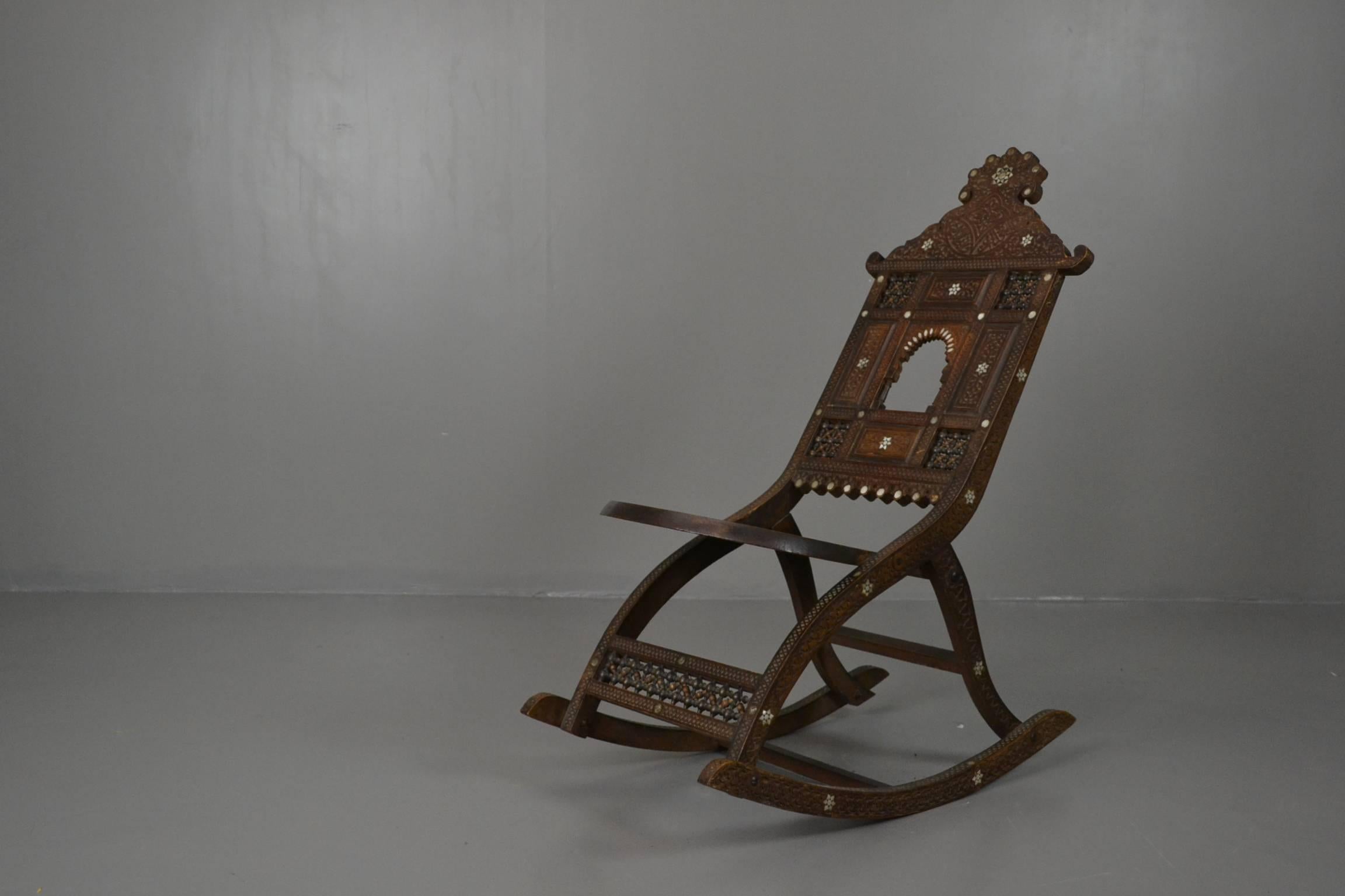 20th century Moorish style rocking chair. Beautifully made with solid hardwood construction with carved and inlaid decoration.

Please click our logo for more items, and to see our full inventory.