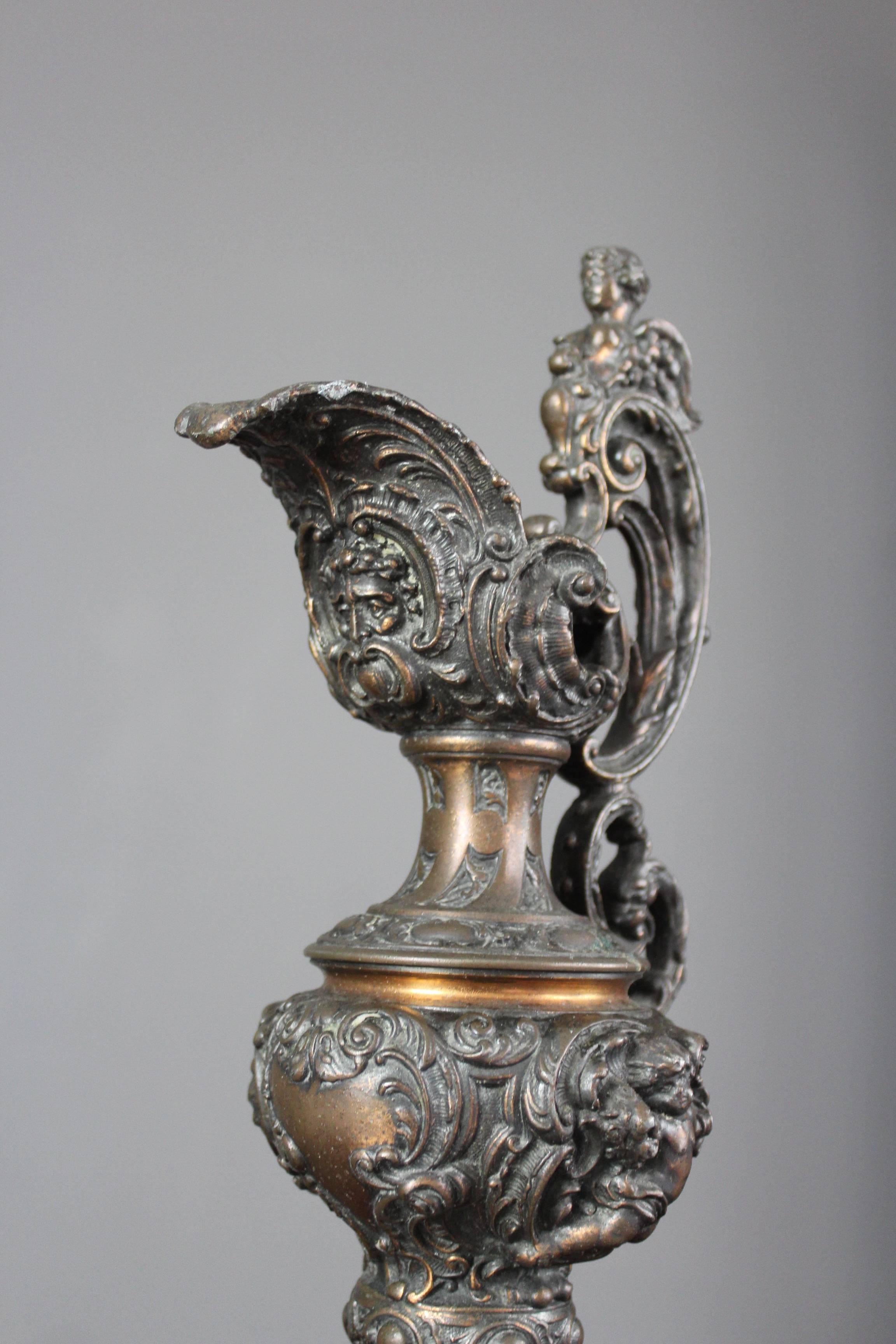 Ornamental Ewer, of spelter and patinated as bronze, moulded with a large spout, narrow neck, the body with children amidst rococo scrolls and foliage, applied with a very ornate handle, formed of c-scrolls and foliage, a sphynx at the top, circa
