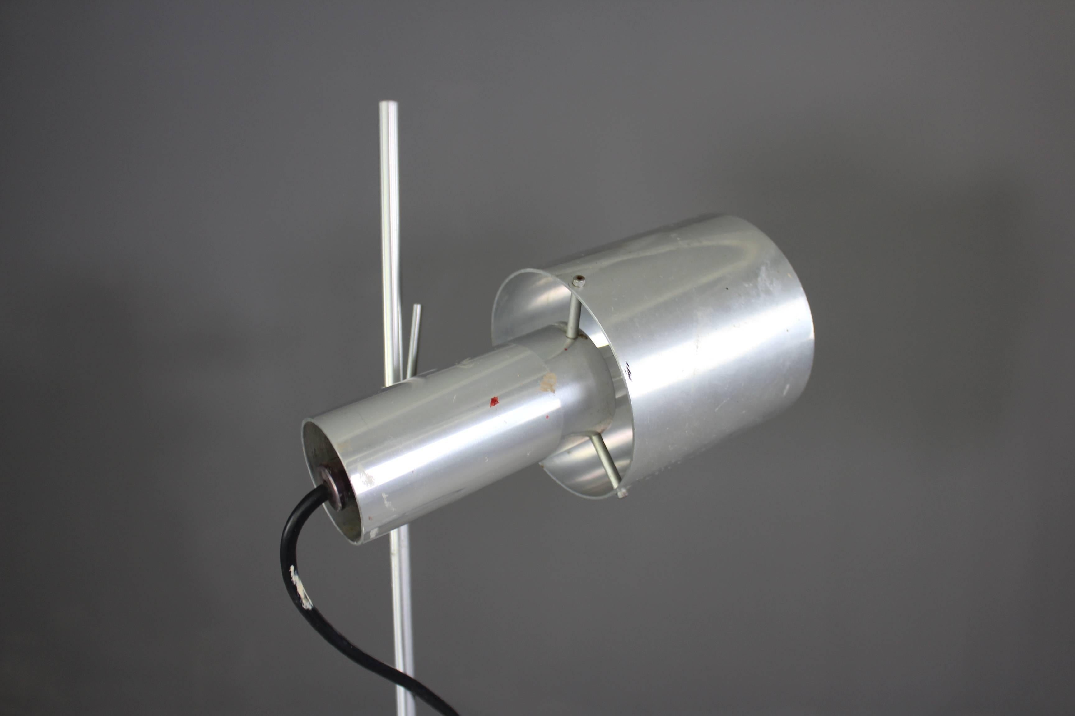 Aluminium floor lamp by Peter Nelson for Architectural lighting. Round base with pair of adjustable aluminium spot lights. Nelson aluminium lights have a modernist design with technical appearance.

Please click our logo for more items, and to see