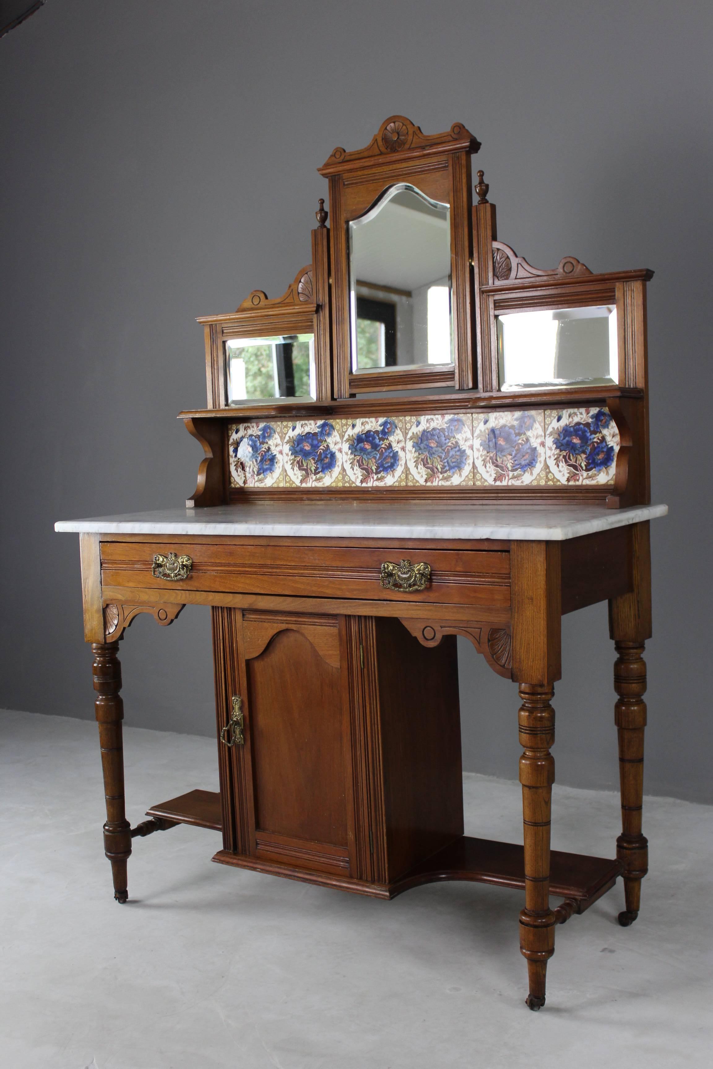 Antique marble-top washstand. Late Victorian walnut washstand with marble top, tiled back splash with mirror above, single drawer and central pot cupboard below on turned legs & castors.

Dimensions: 107 cm wide x 48 cm deep x 79 cm high x 157 cm