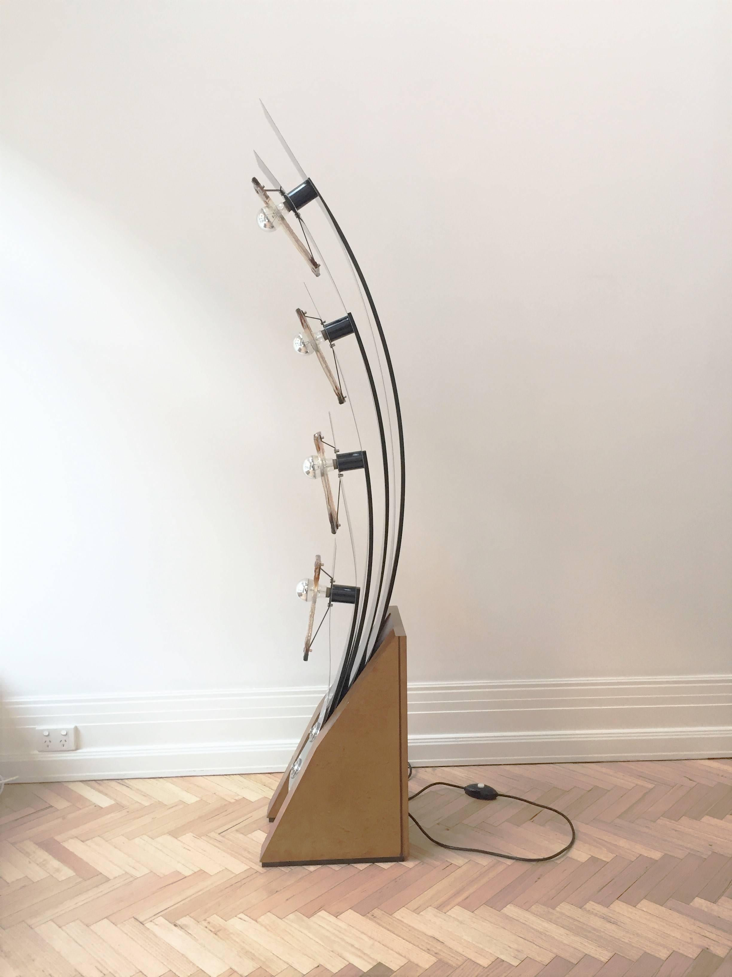 A most unique one off piece for your home. This 1970's, Mazzega glass peacock tail floor lamp consists of 4 glass panels and 4 lights. The structure comprises of a bur walnut veneer wood base with 5 stainless steel shards of which resemble a