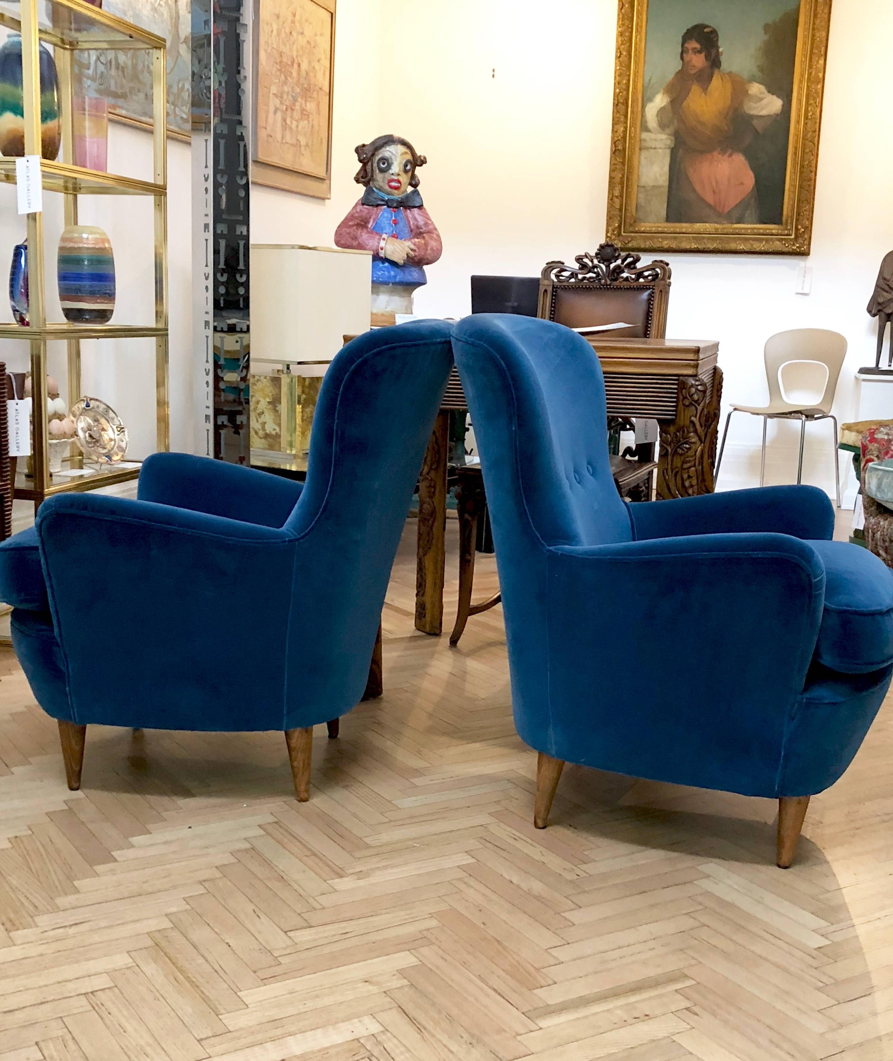 This pair of Italian 1950s lounge chairs are super comfortable and have been upholstered in a dust blue velvet.