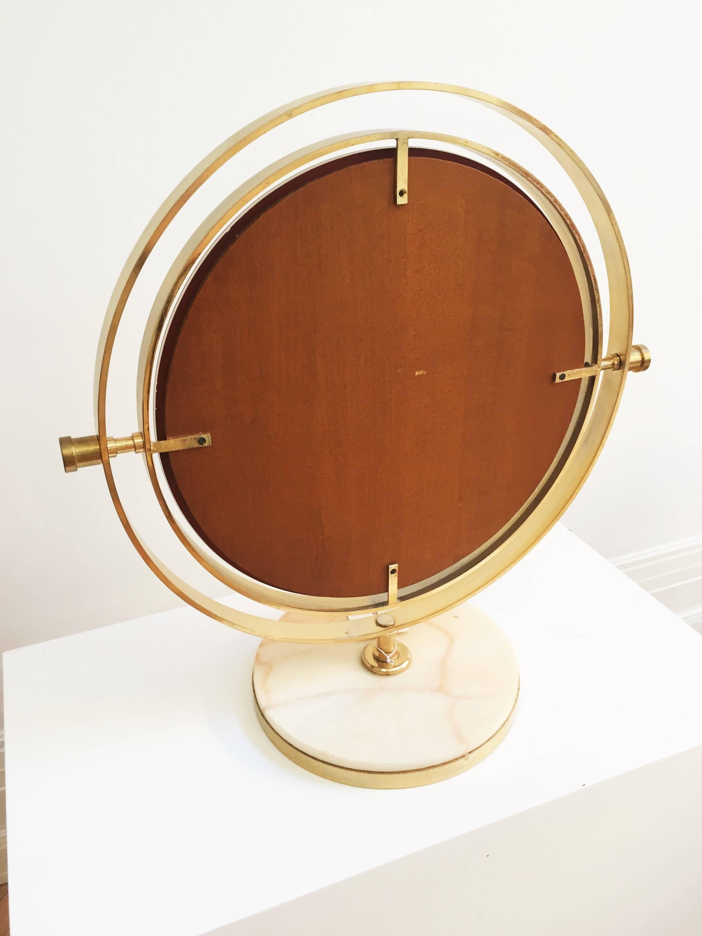 Rare 1950s quality brass and marble, swivel Table Mirror Attributed to Sergio Mazza. This rare mirror has over-sized proportions giving it the wow factor.
Engineered in high quality brass with a cream marble base. The diameter of the base is 30 cm
