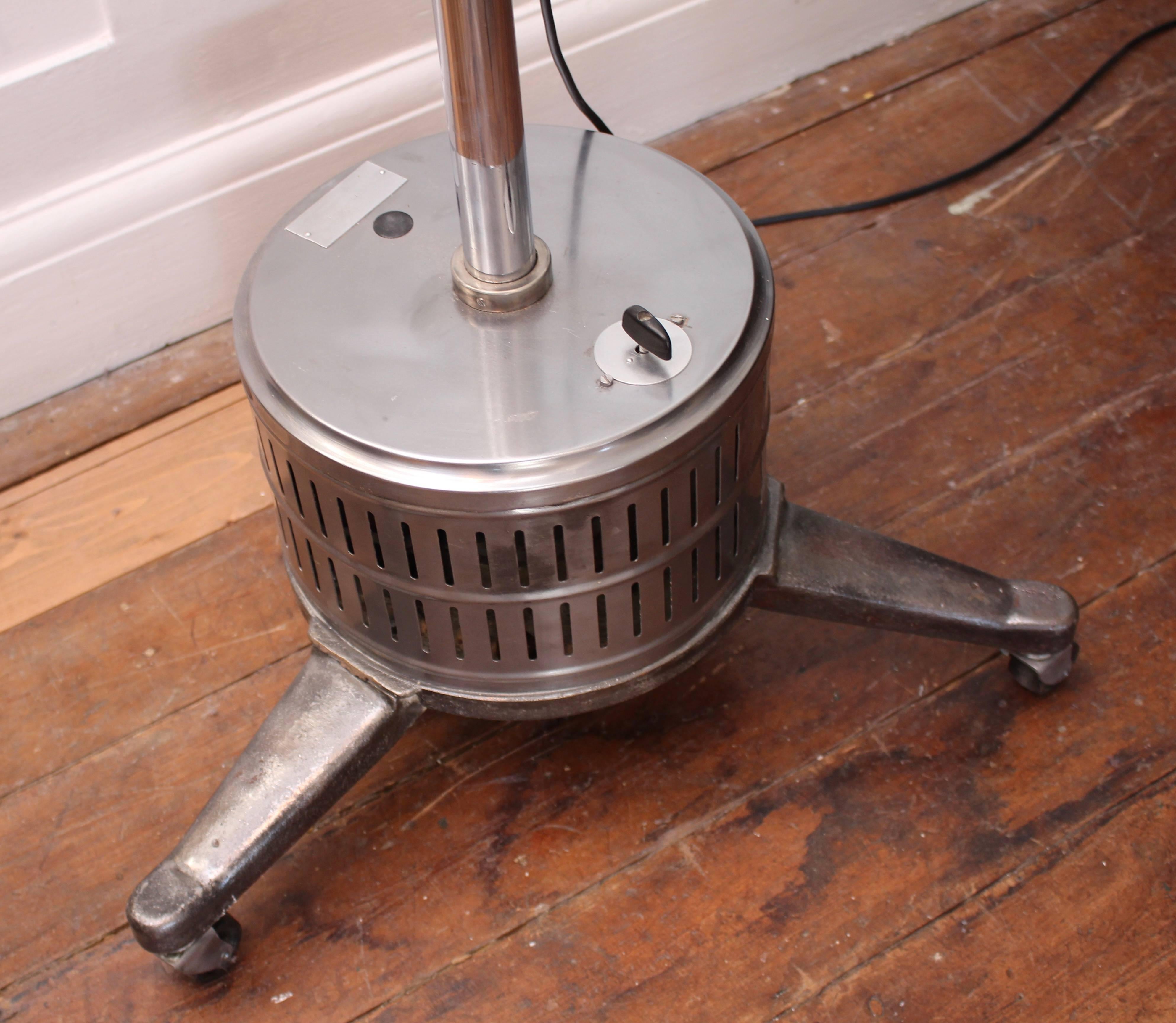 Extremely large restored medical theatre light on trolley base. This lamp is extremely heavy and really has a stylish look to it. The trolley base and light shade have been professionally stripped and polished while the light has been rewired and