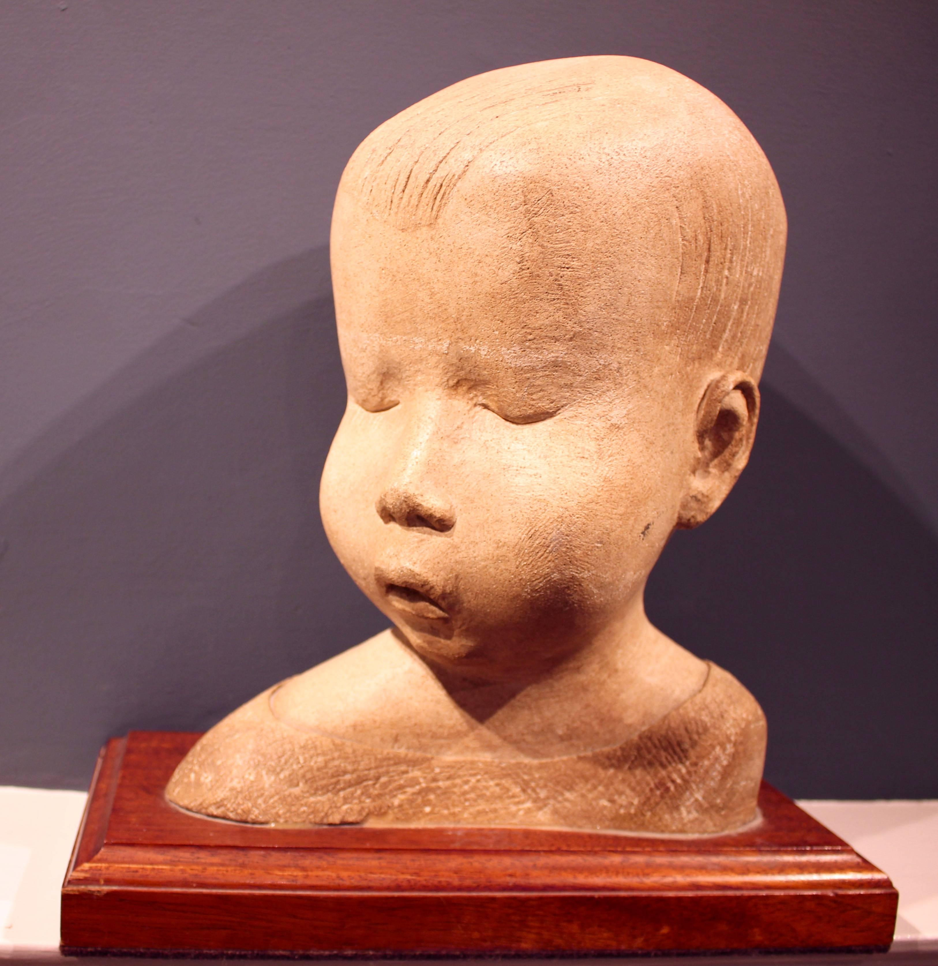 A lovely carved stone sculpture of a young child. Originally purchased by my client's father in the 1930s and housed in his Harley Street clinic in London for many years until his retirement. A very stylised piece with beautiful soft lines. Standing