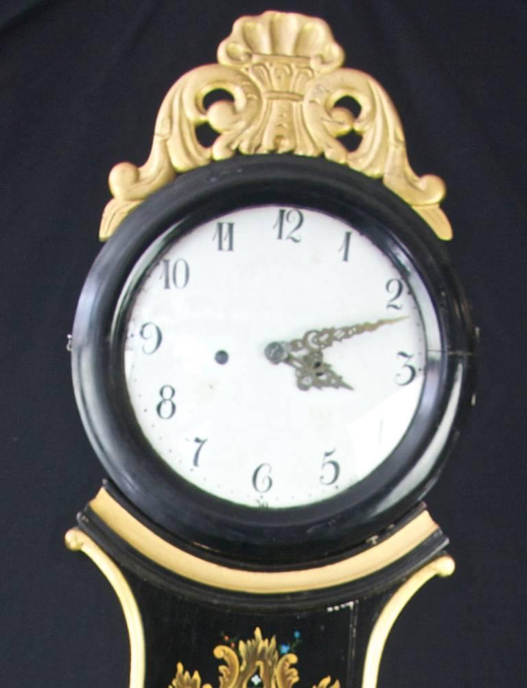 Rare exemple d'une horloge mora suédoise ancienne des années 1800 très décorative avec de superbes détails peints à la main sur la finition.

Cette horloge mora originale du début des années 1800 a un beau visage avec une patine propre, une