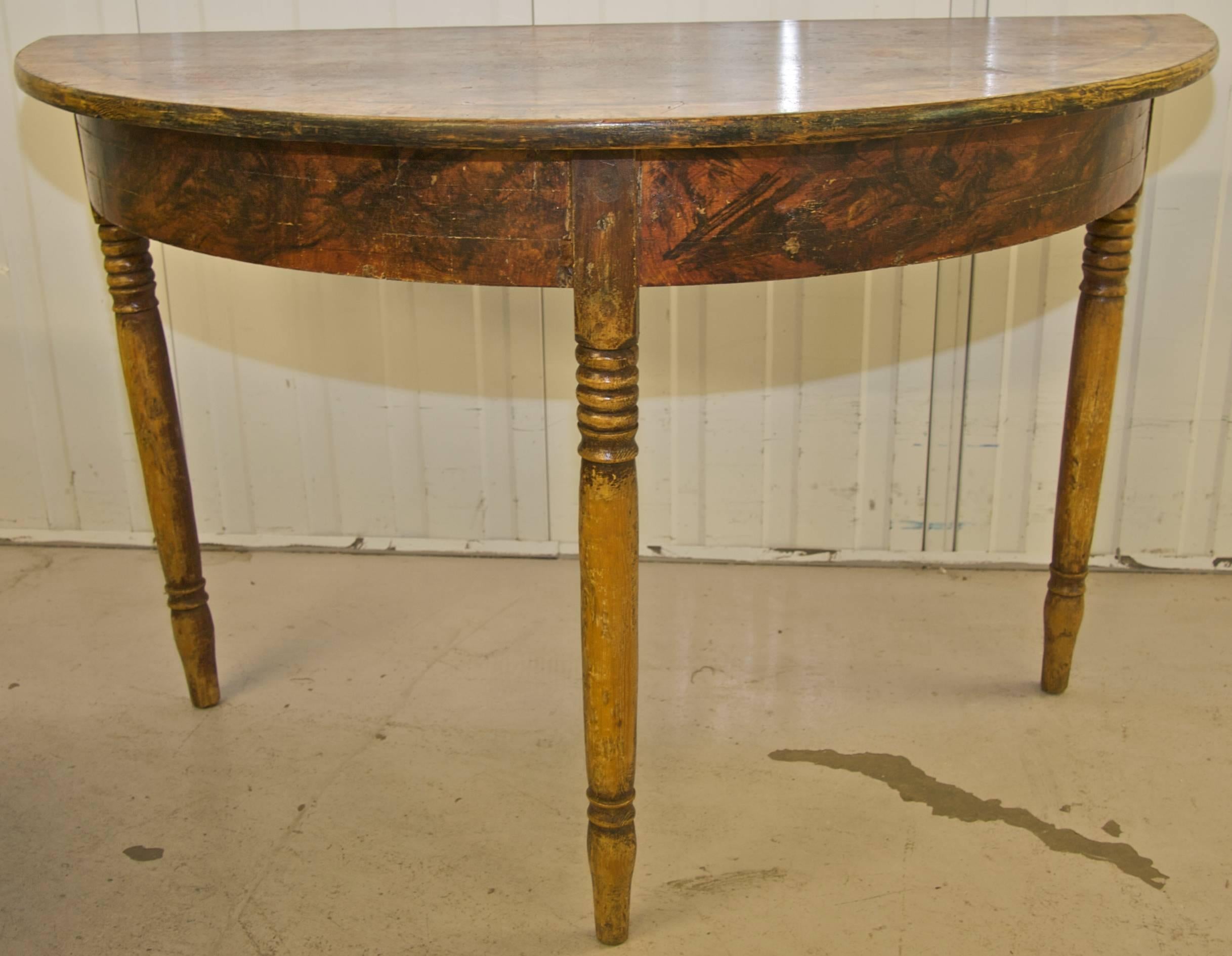 Rare pair of North Swedish Gustavian demilune tables hand decorated in delicious faux wood grain in the Classic Kurbits Folk Art tradition.

Lovely slender Gustavian Style legs.

The tables have acquired a lovely patina of age and are structurally