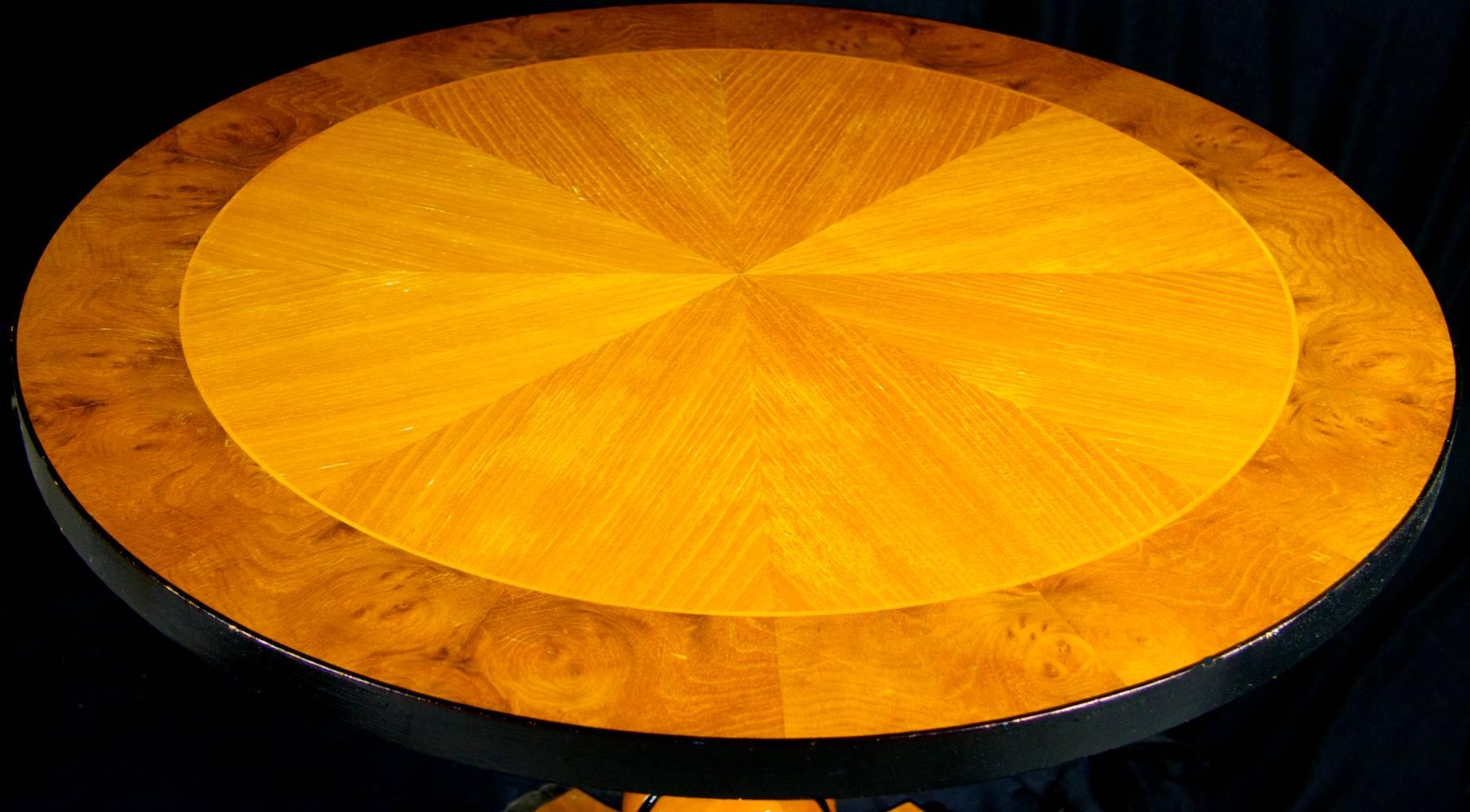 Stunning Swedish Biedermeier table with top grade golden birch flame veneers in an inlaid 8th veneer pattern with ormolu detail on the edge, pedestal, feet and base finished in the desirable honey color golden birch French polish finish.

Very