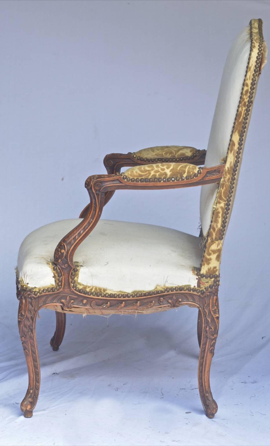 This is a Classic pair of original French oversized Rococo Bergere style armchairs from the late 19th century with carved Rococo arms and legs in a Classic rich brown muted French polish finish and with unusual delicately curved feet.

The extra