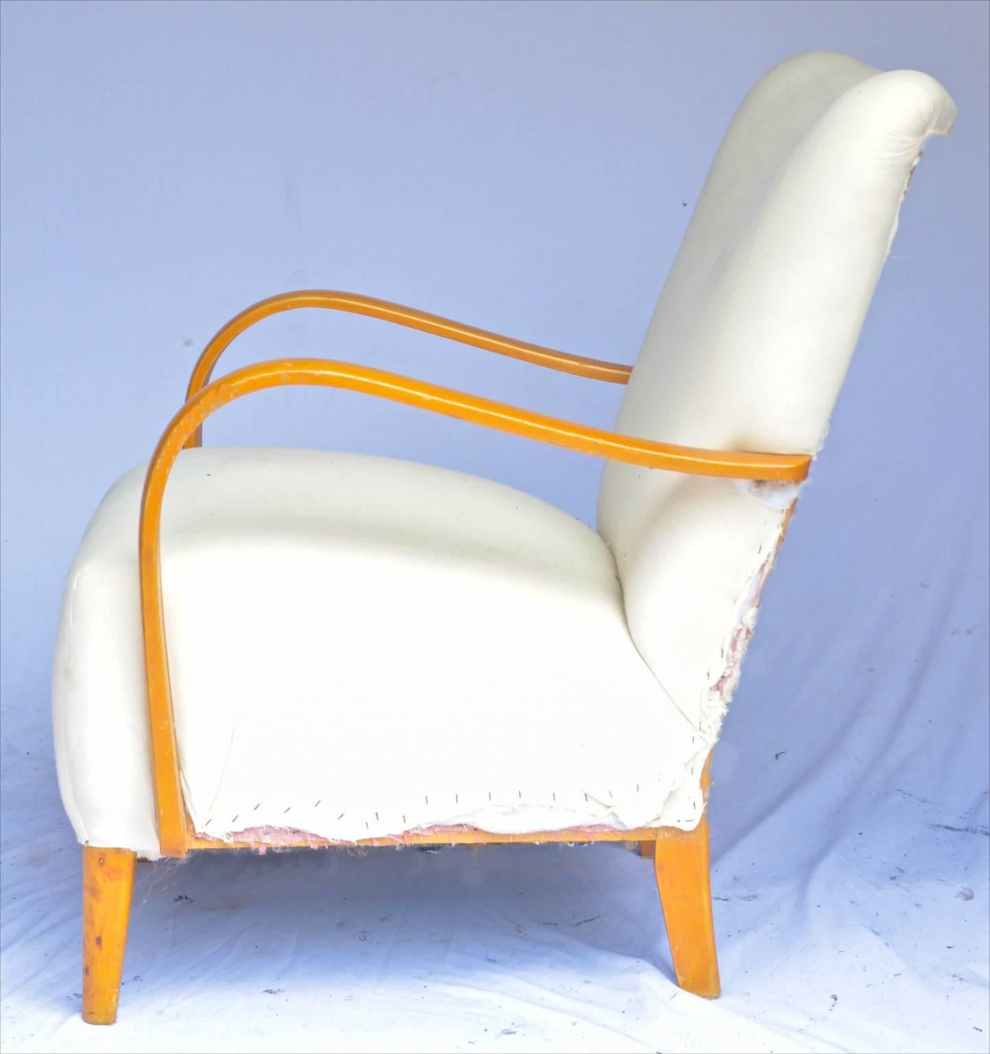 This is a Classic pair of original Swedish Art Deco armchairs with golden birch bentwood arms in a rich honey color French polish finish and with unusual simple feet. They are crossover pieces from later Art Deco into Swedish Modern and are a