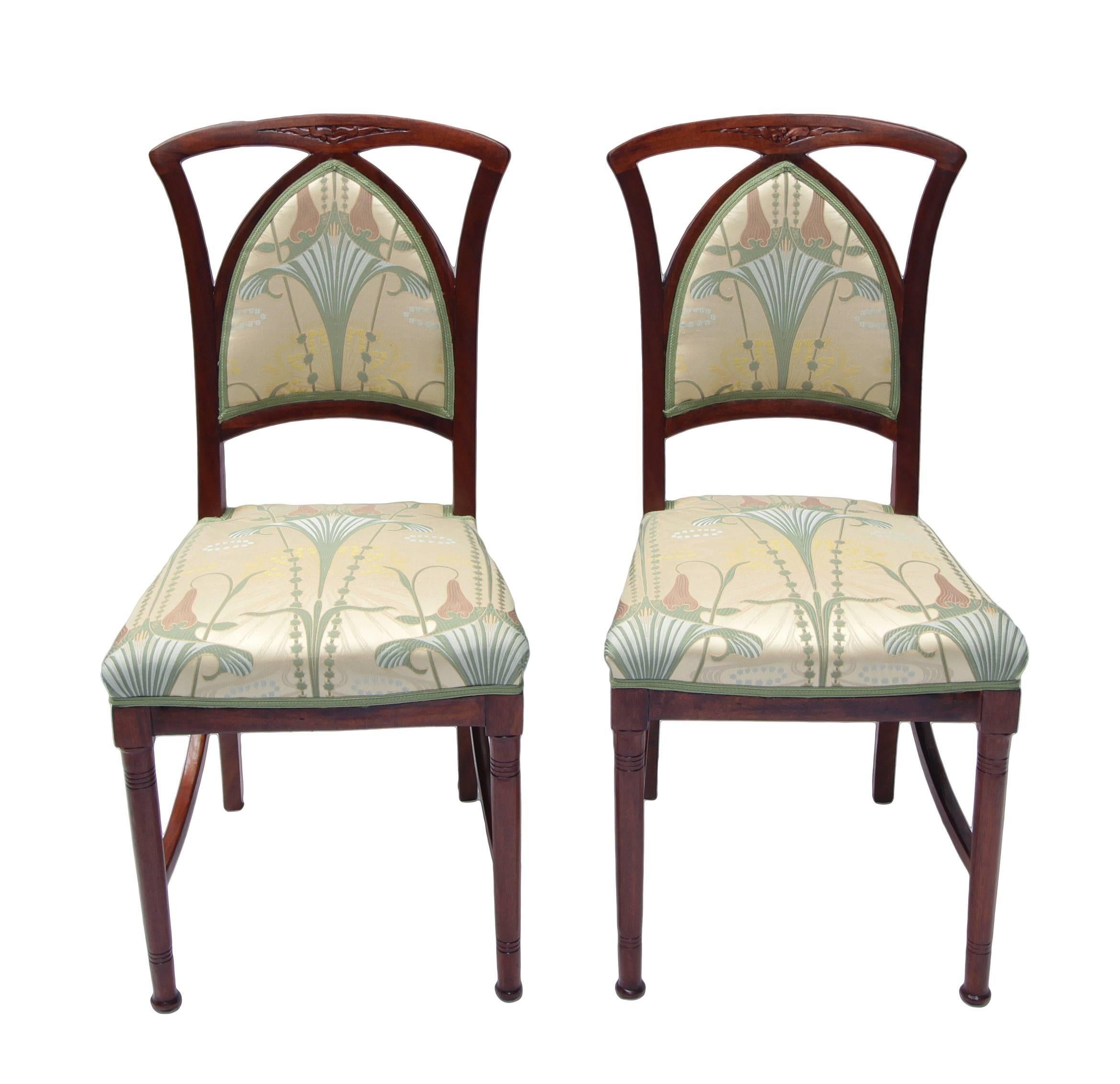 This lounge set consists of two side chairs, two-arm armchairs, and one sofa from the Art Nouveau period and is made from mahogany. The set has completely new upholstered with an Art Nouveau fabric according to a design by Atelier Ruepp from Paris