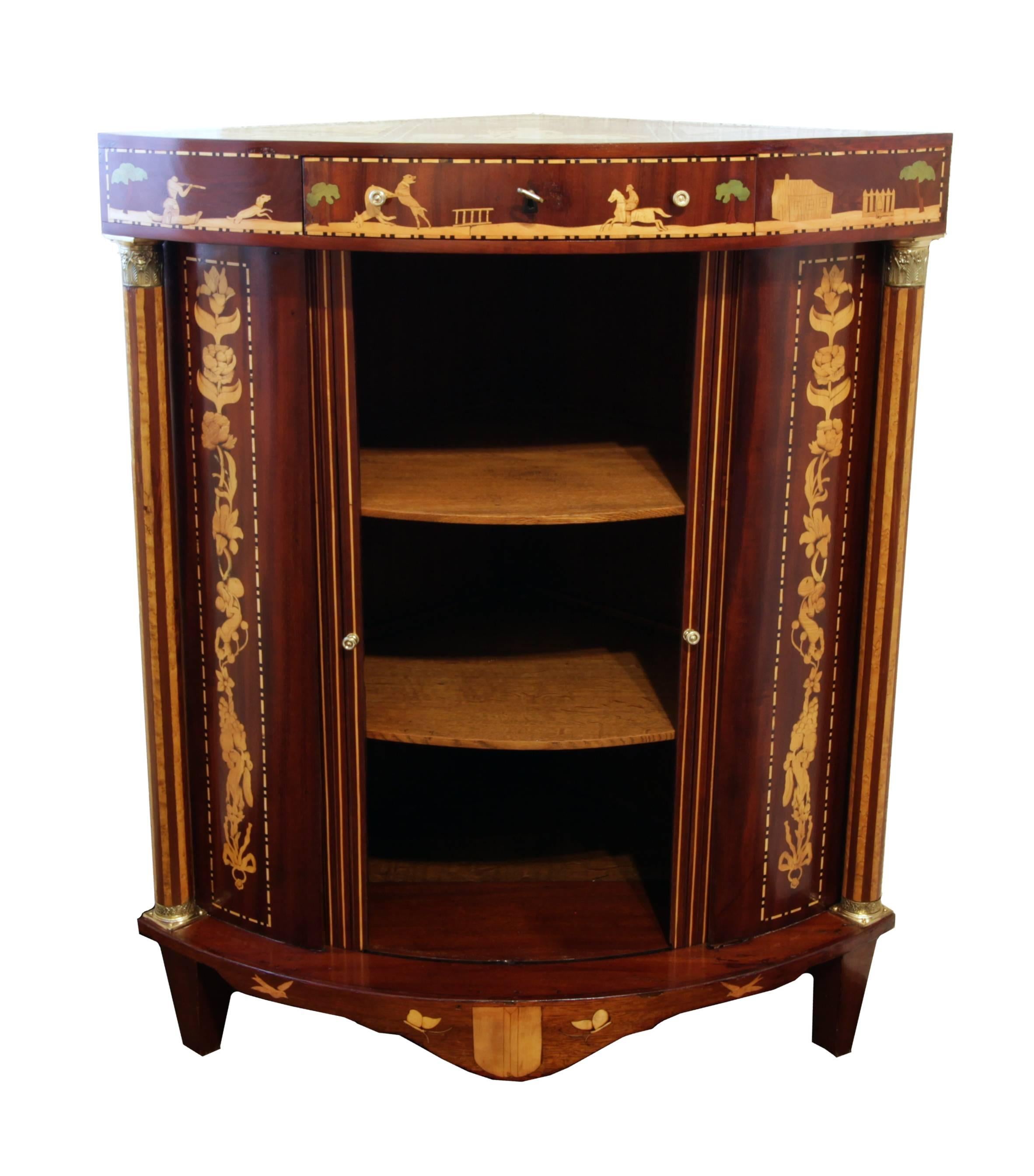 Louis XVI Corner cabinet with a very beautiful marquetry made of nutwood, maple and ebony at a solid oak corpus. With two sliding doors and a drawer. 