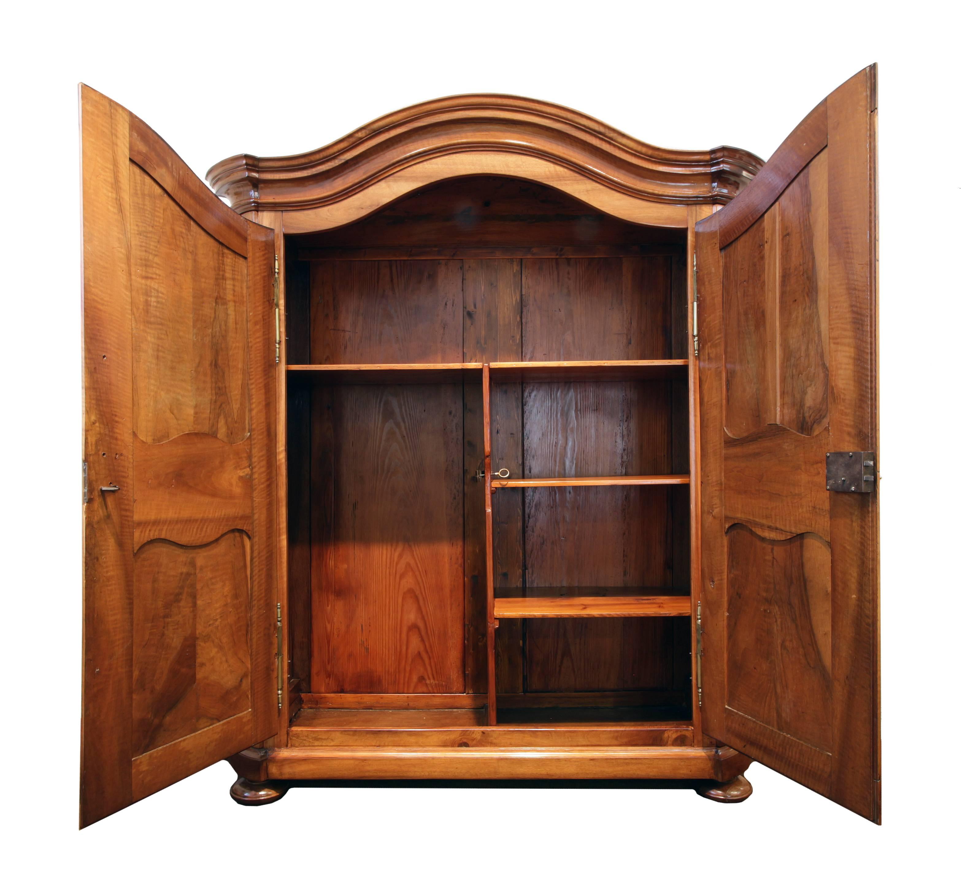 Very beautiful Baroque wardrobe made of solid walnut. Backboard and interior division consists of pinewood, as usual. The closet is in a very good restored condition. The interior is available as you can see in the photo. If desired, the interior