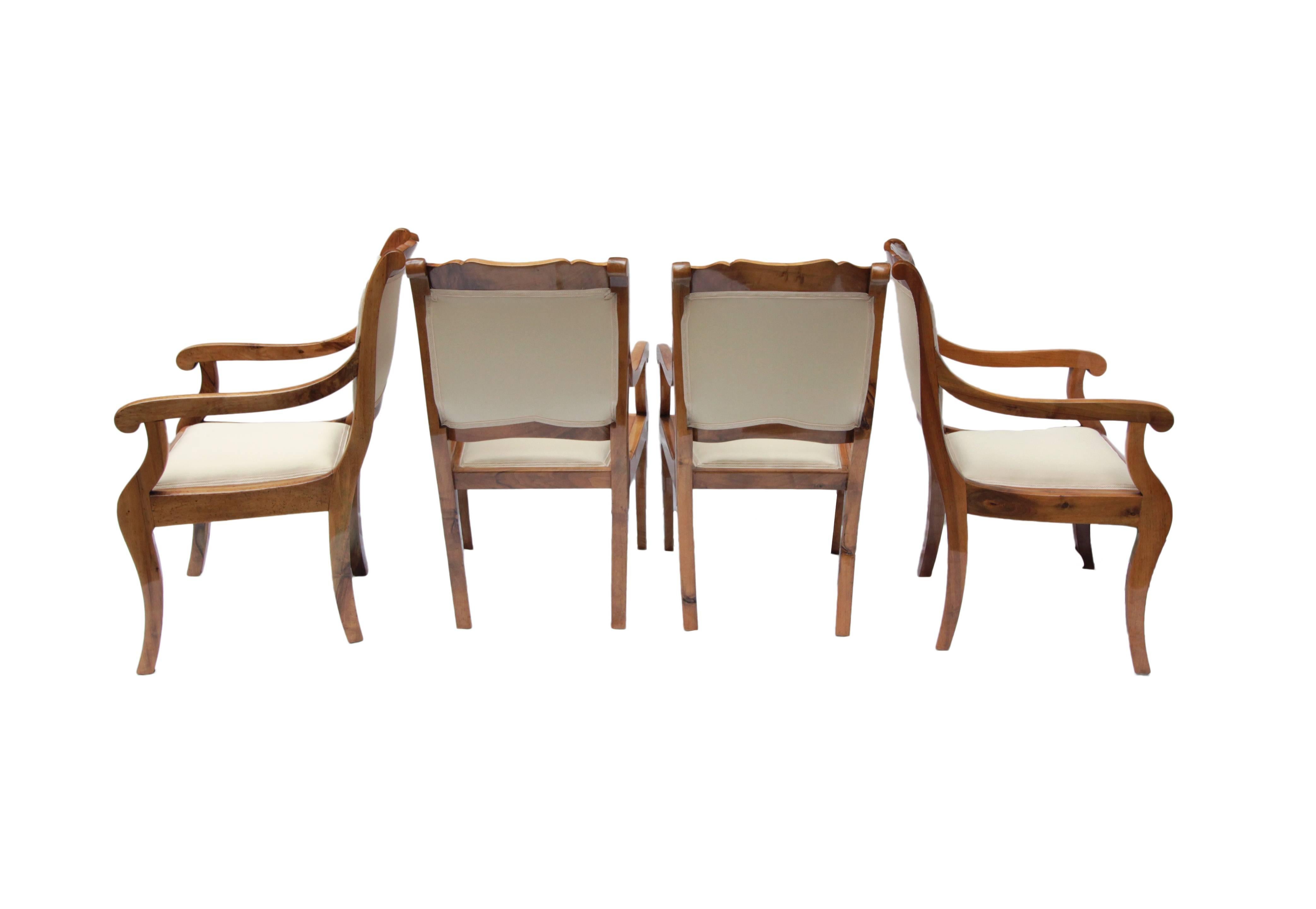 The rare set consists of four solid walnut armchairs from the Biedermeier period. The armchairs are newly upholstered and very well restored. The seat height is relatively high, so you can sit well at a table.