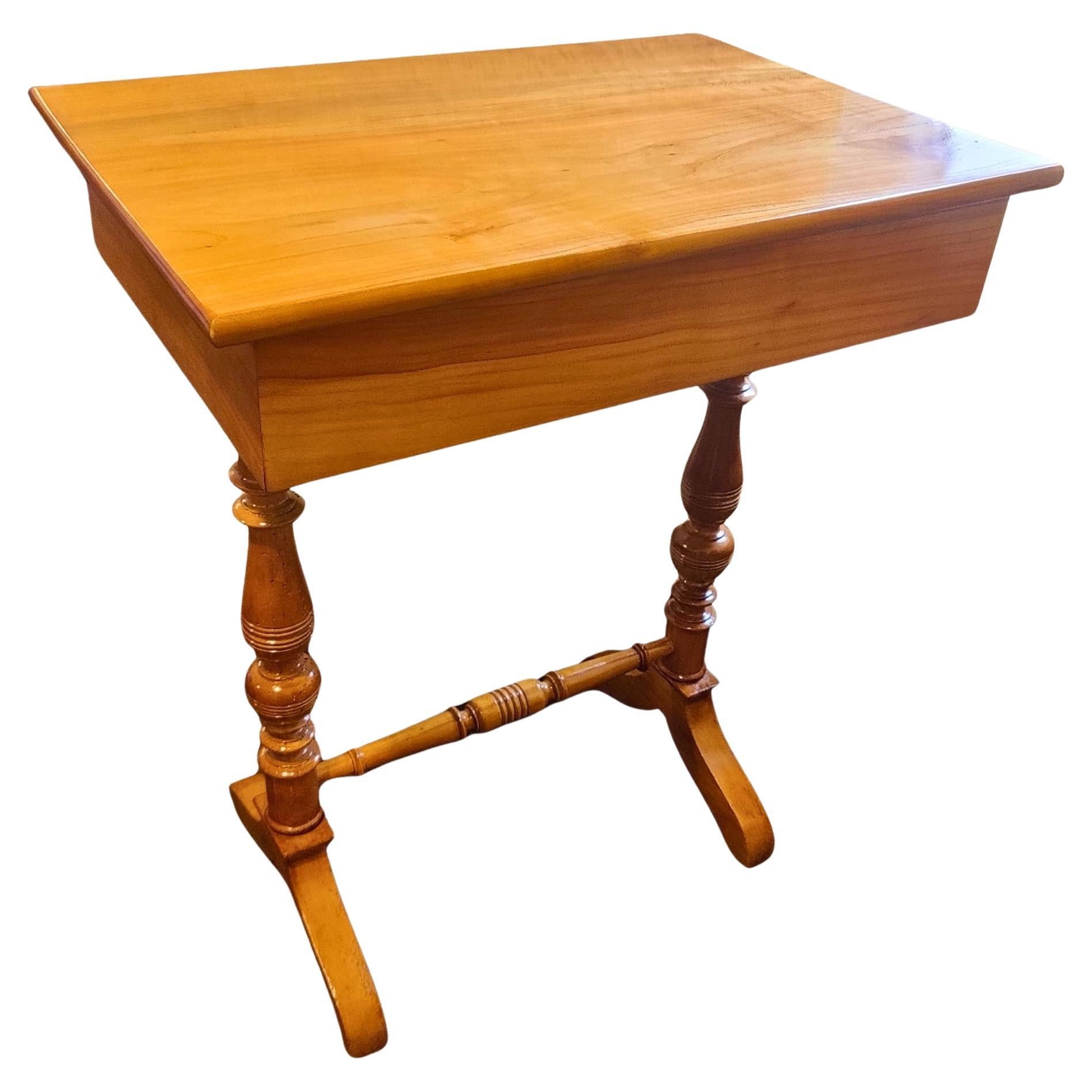 his elegant side table originates from the late Biedermeier to early Historicism period, around 1850. The piece is crafted from solid cherrywood with a beautifully warm, honey-colored surface that highlights the fine natural grain. Its design is
