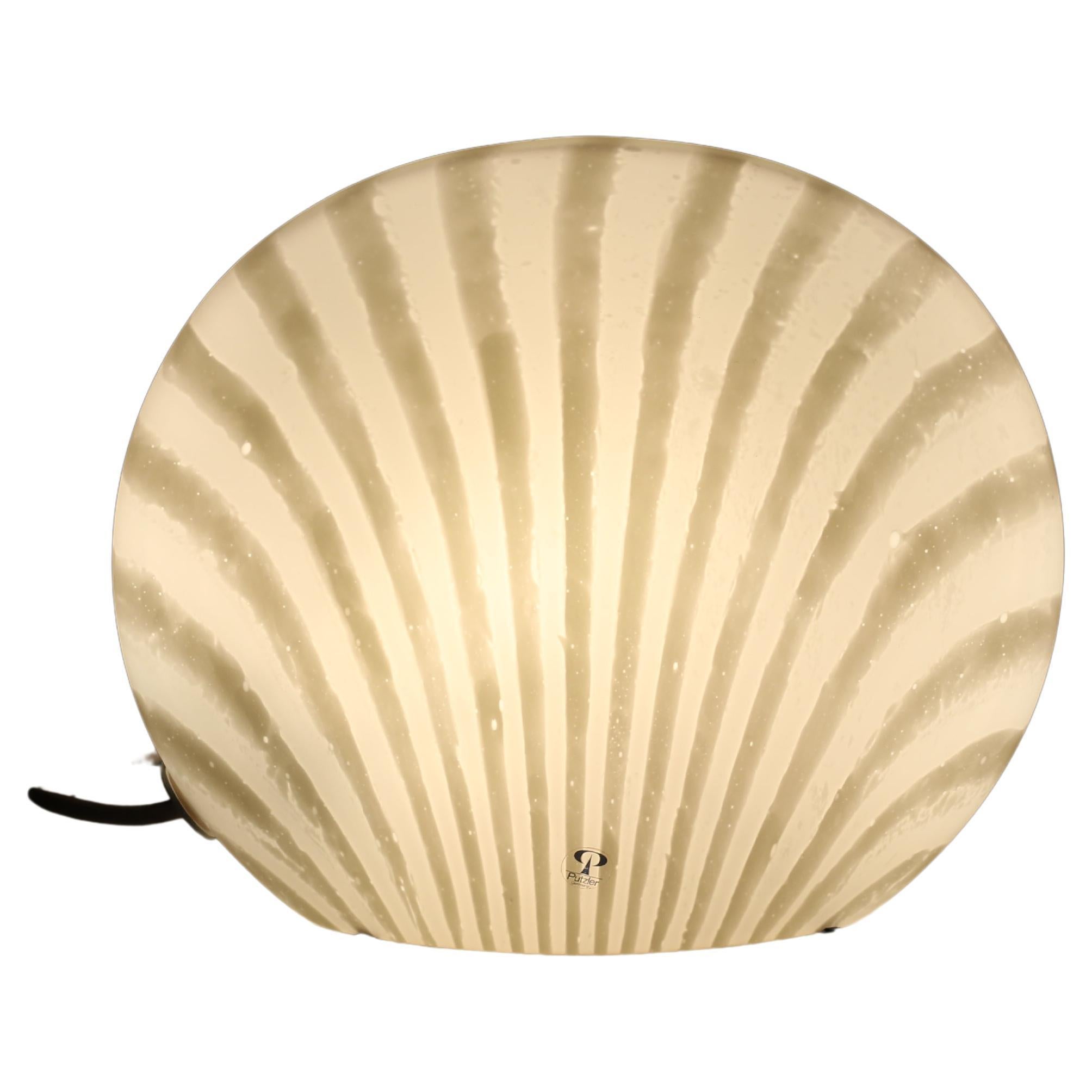 A Mid-Century Modern Peill & Putzler glass sea shell desk light or table light made in West Germany, in or around the 1960’s. 

This highly tactile and very smooth to the touch seashell light is made from a seamless piece of continuous flowing