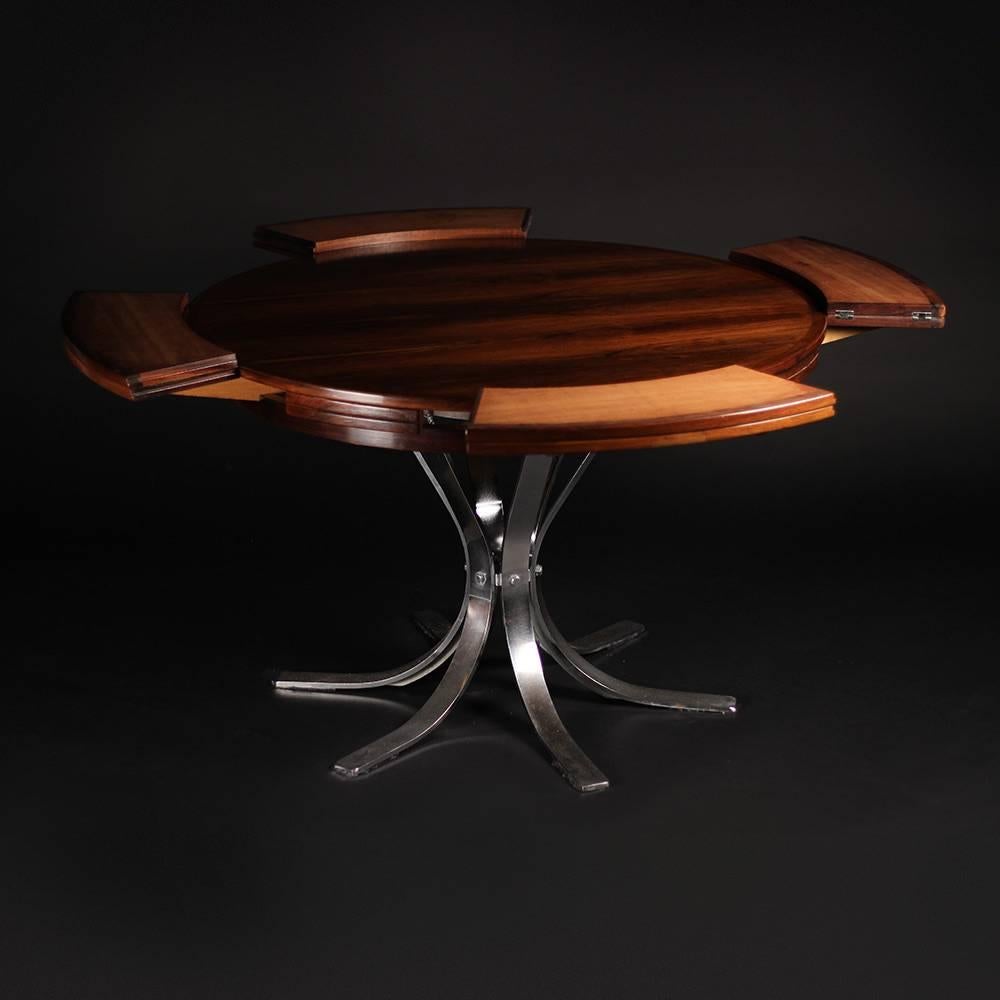 An extremely rare and mechanically brilliant flip flap or lotus rosewood table. The choice of grain in the Rosewood is nothing short of beautiful and exactly what you would expect from a well respected maker such as Dyrlund. The table ingeniously