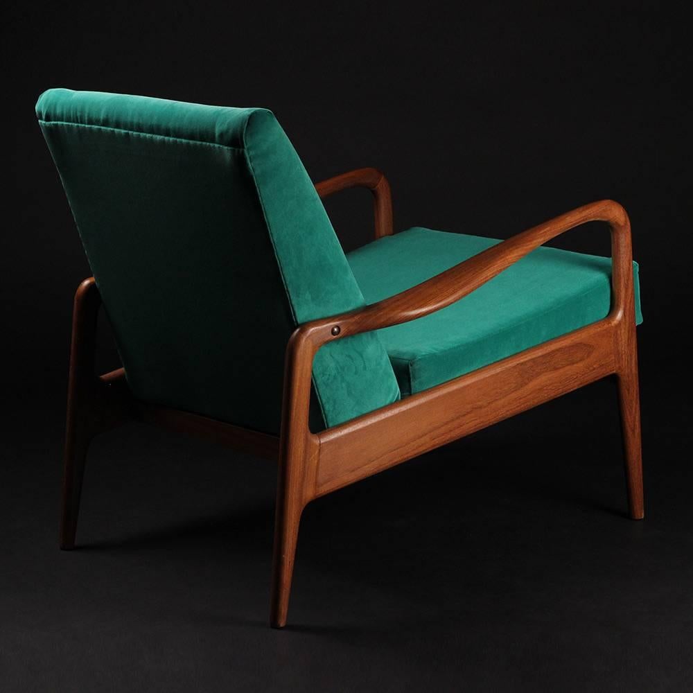 A British-made and designed lounge chair by Greaves & Thomas of Mayfair produced, circa 1960s. With beautiful curved solid Afrormosia (African Teak) arms and angled legs, this chair has recently been reupholstered in an Italian velvet.