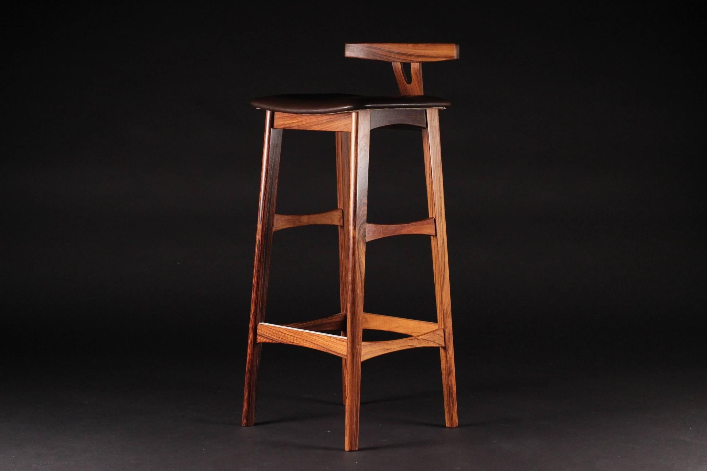 A matching pair of leather and rosewood upholstered stools in very good original condition.