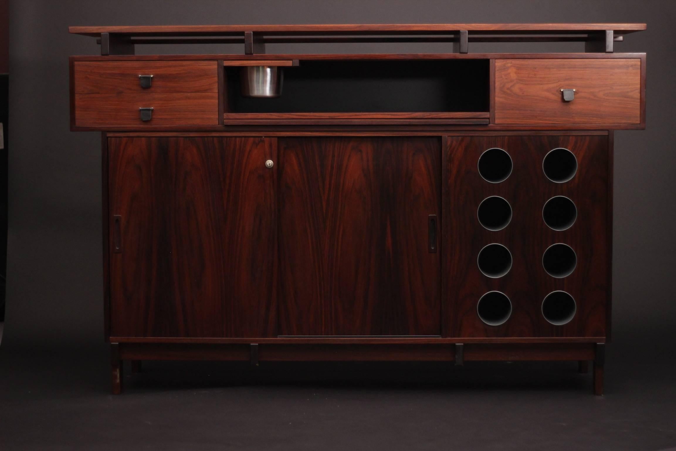 Exceptional rosewood bar by the danish quality furniture makers Dyrulund this piece has a real scale and presence. This Timeless piece of Scandinavian Modern Design is in very good condition Having professionally restored by our craftsman. 
With a